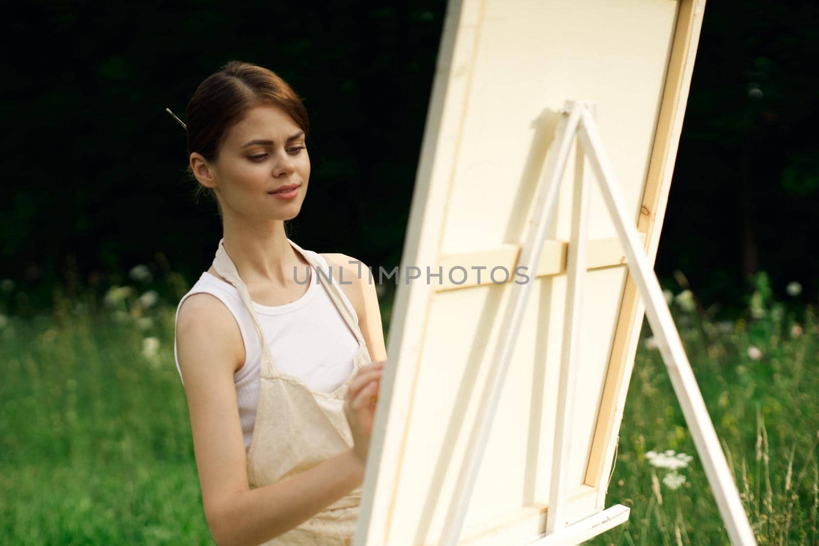 woman artist paints a picture near easel outdoors landscape creative by Vichizh