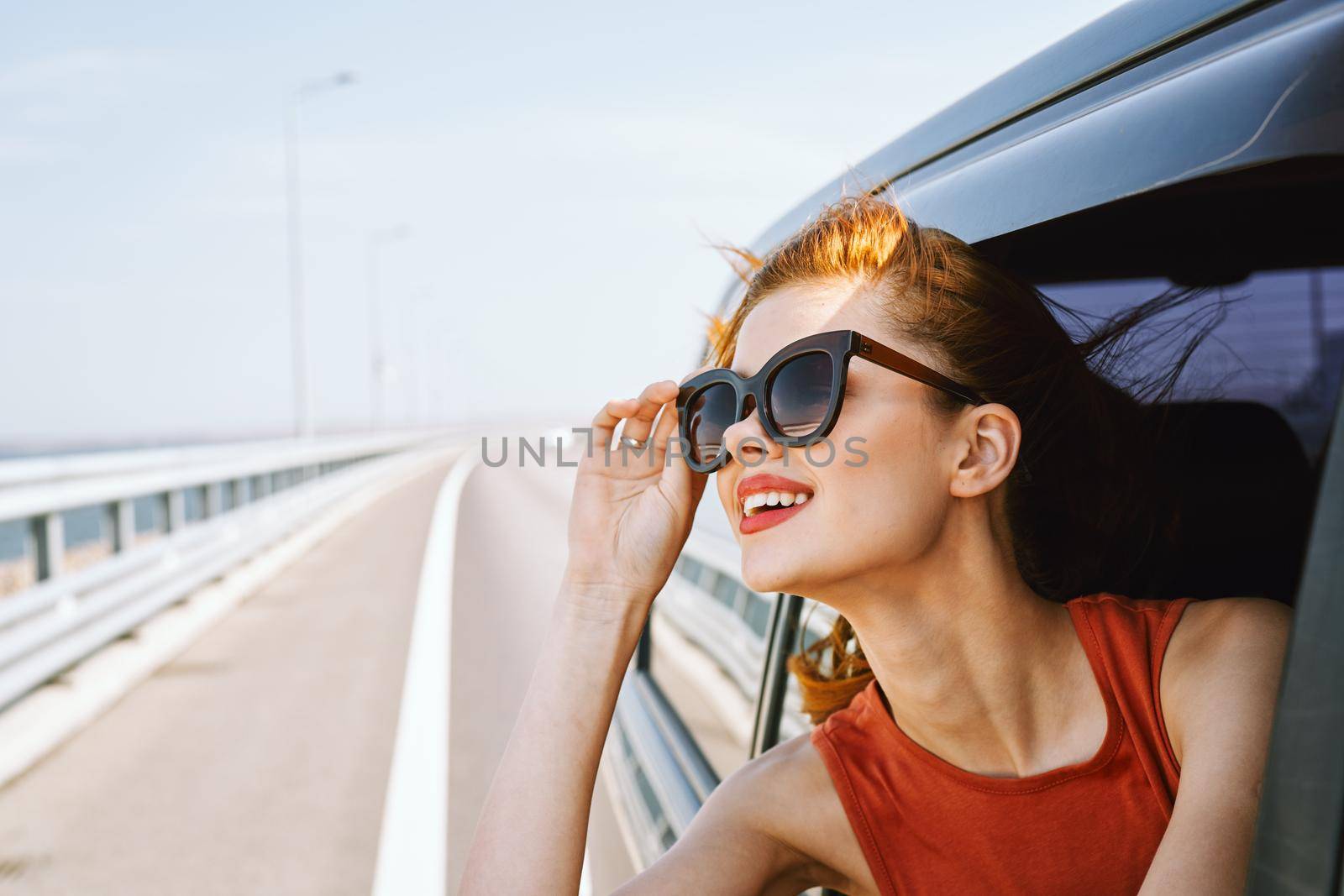 pretty woman in sunglasses rides in a travel car by Vichizh