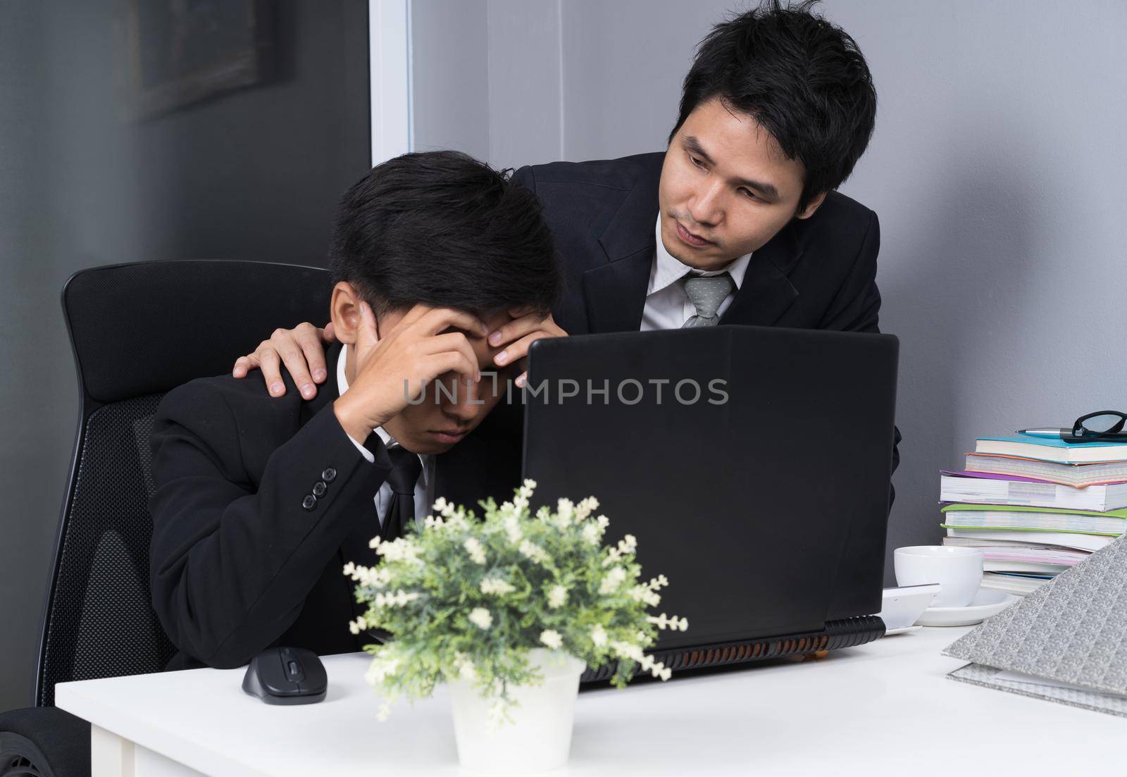 serious stressed two business man using laptop computer to working project