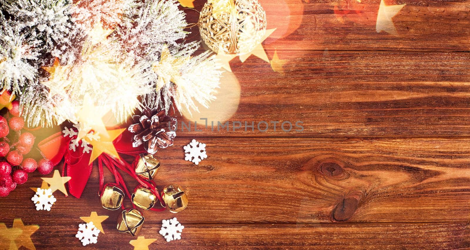 Christmas composition of spruce branches, gift, cinnamon, anise and confetti stars on rustic wooden background. Flat plan, top view by Maximusnd