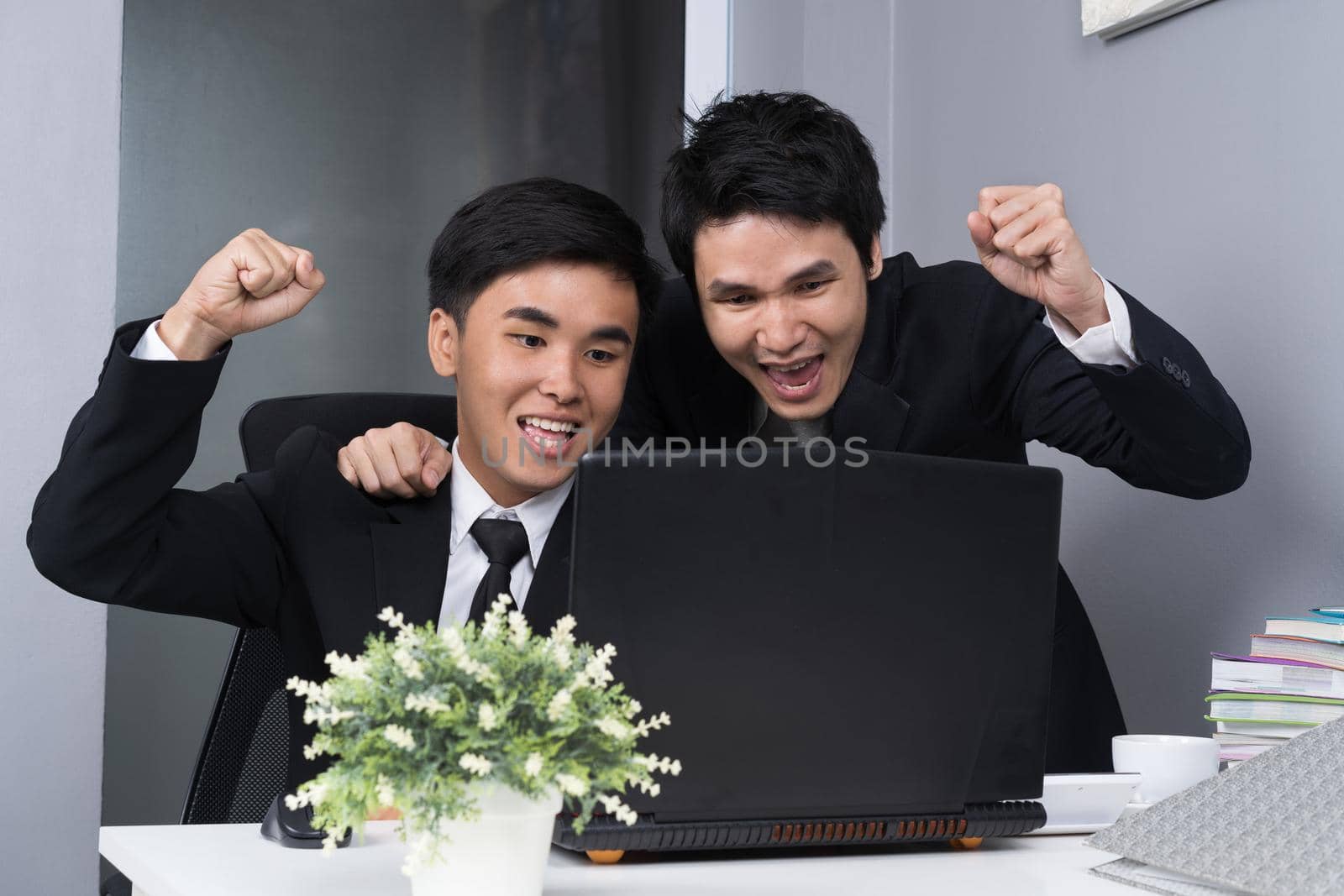 happy two business man using laptop to  successful working project by geargodz
