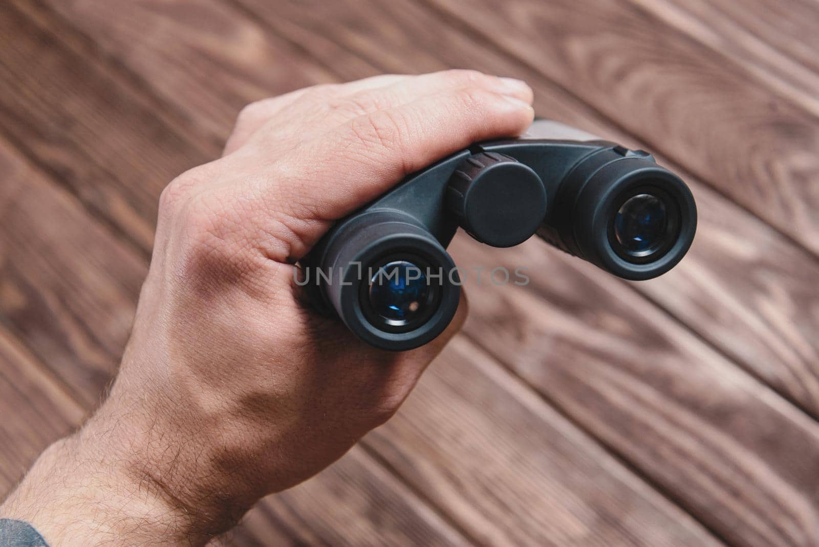 Hand with binoculars. by alexAleksei