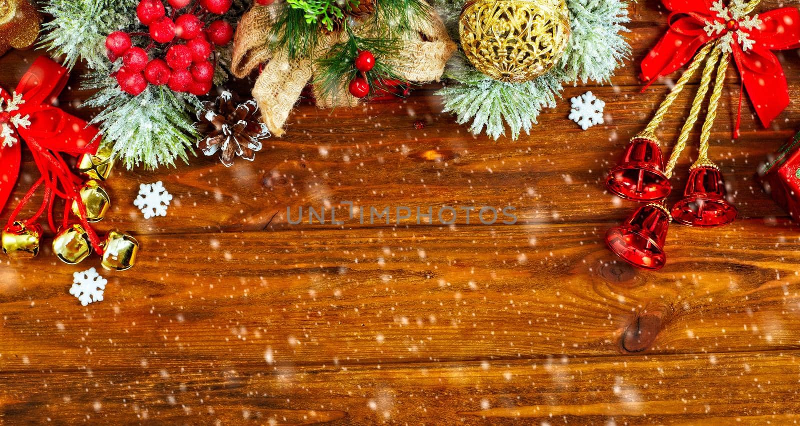 Christmas composition of spruce branches, gift, cinnamon, anise and confetti stars on rustic wooden background. Flat plan, top view