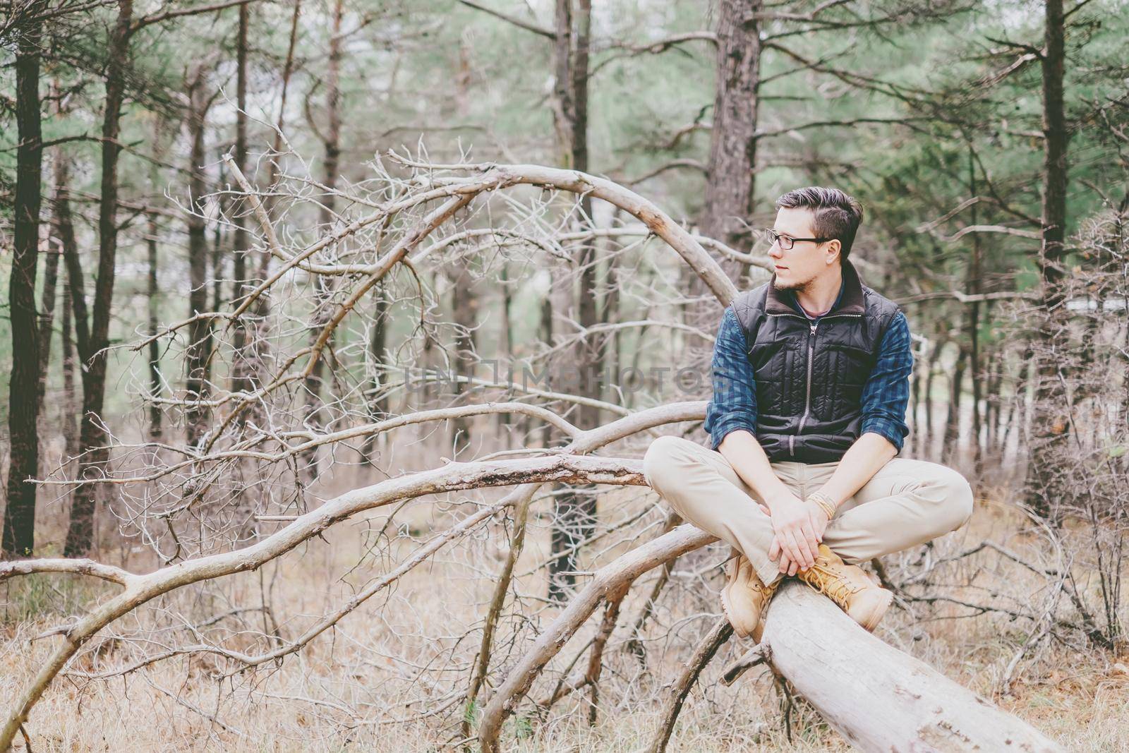 Explorer young man rests in the woods.