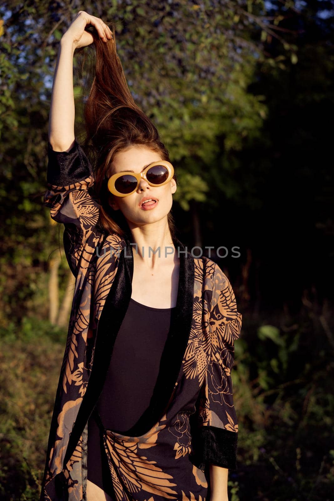 woman wearing sunglasses outdoors posing fashion. High quality photo