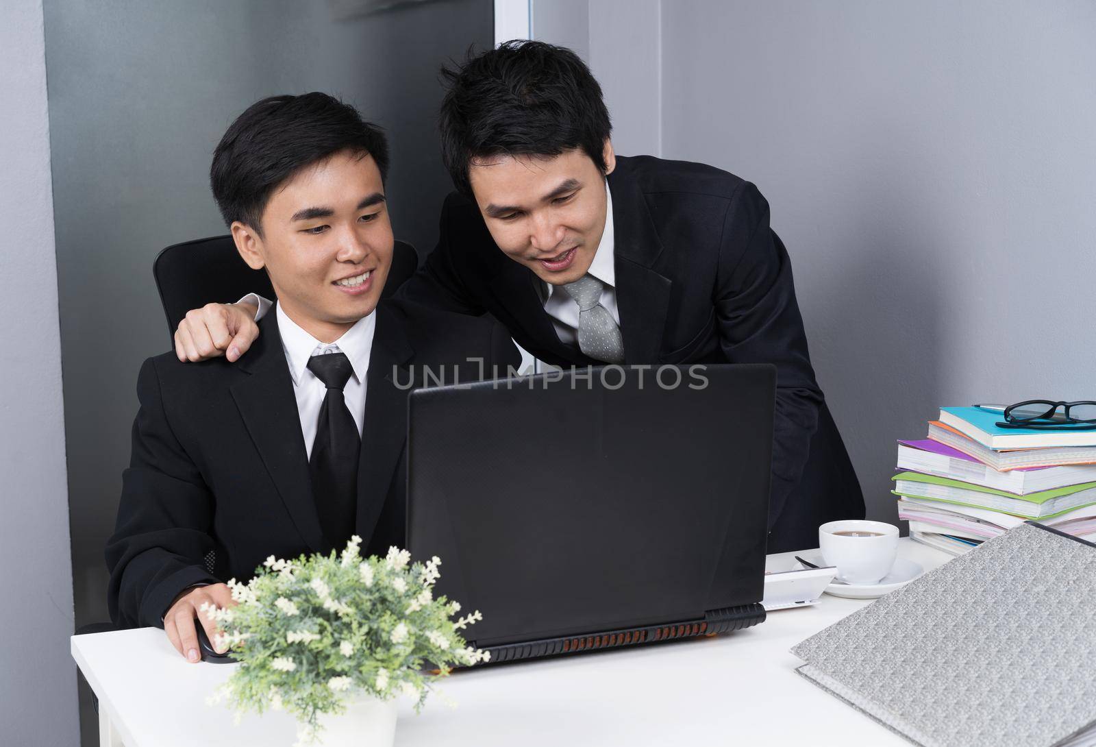 two business man laughing while using laptop computer by geargodz