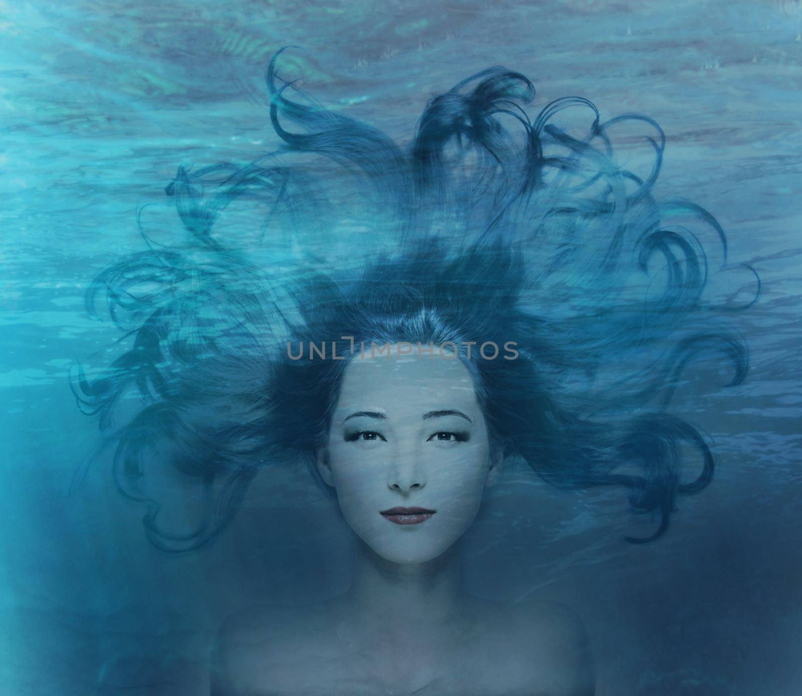 Double exposure beautiful mermaid young woman with blue hair combined with image of deep sea.