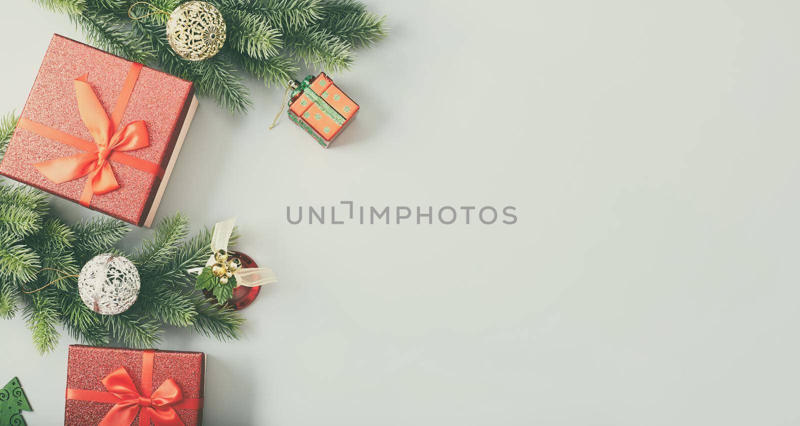 Frame of twigs christmas tree, brown natural pine cones and red berries on snow with space for text. Top view, flat lay by Maximusnd