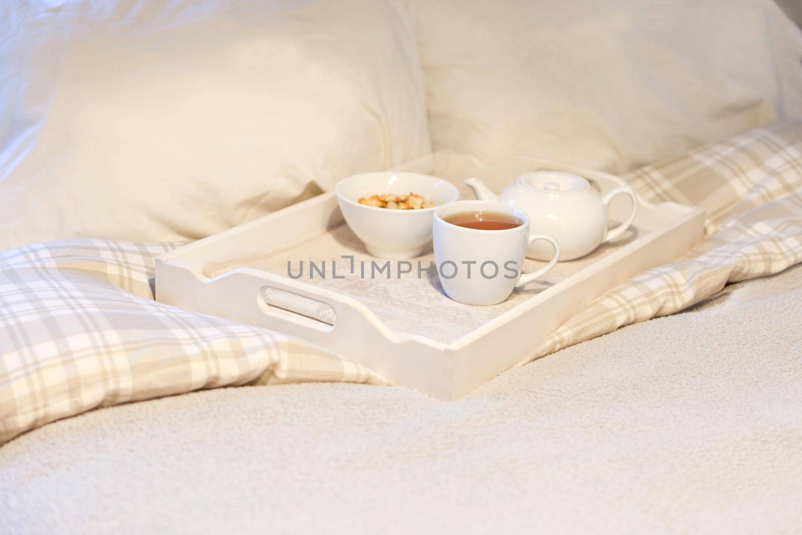 morning breakfast with cookies at bed- striped teaset on breakfast tray in white bedroom