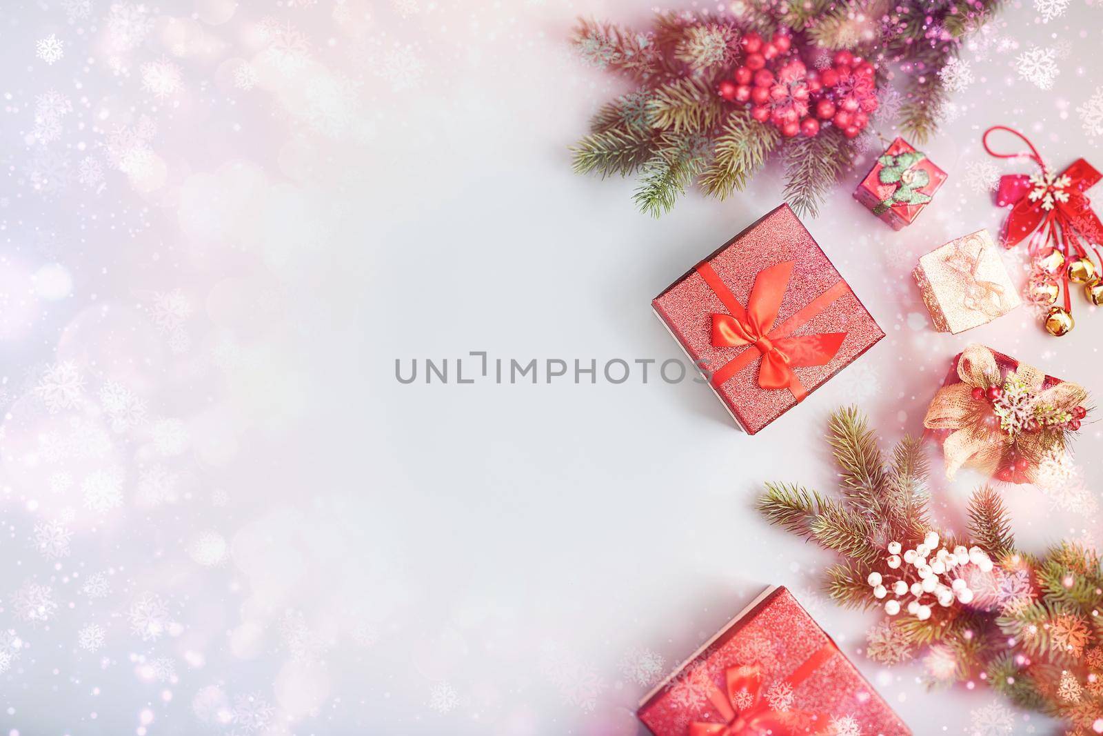 Frame of twigs christmas tree, brown natural pine cones and red berries on snow with space for text. Top view, flat lay