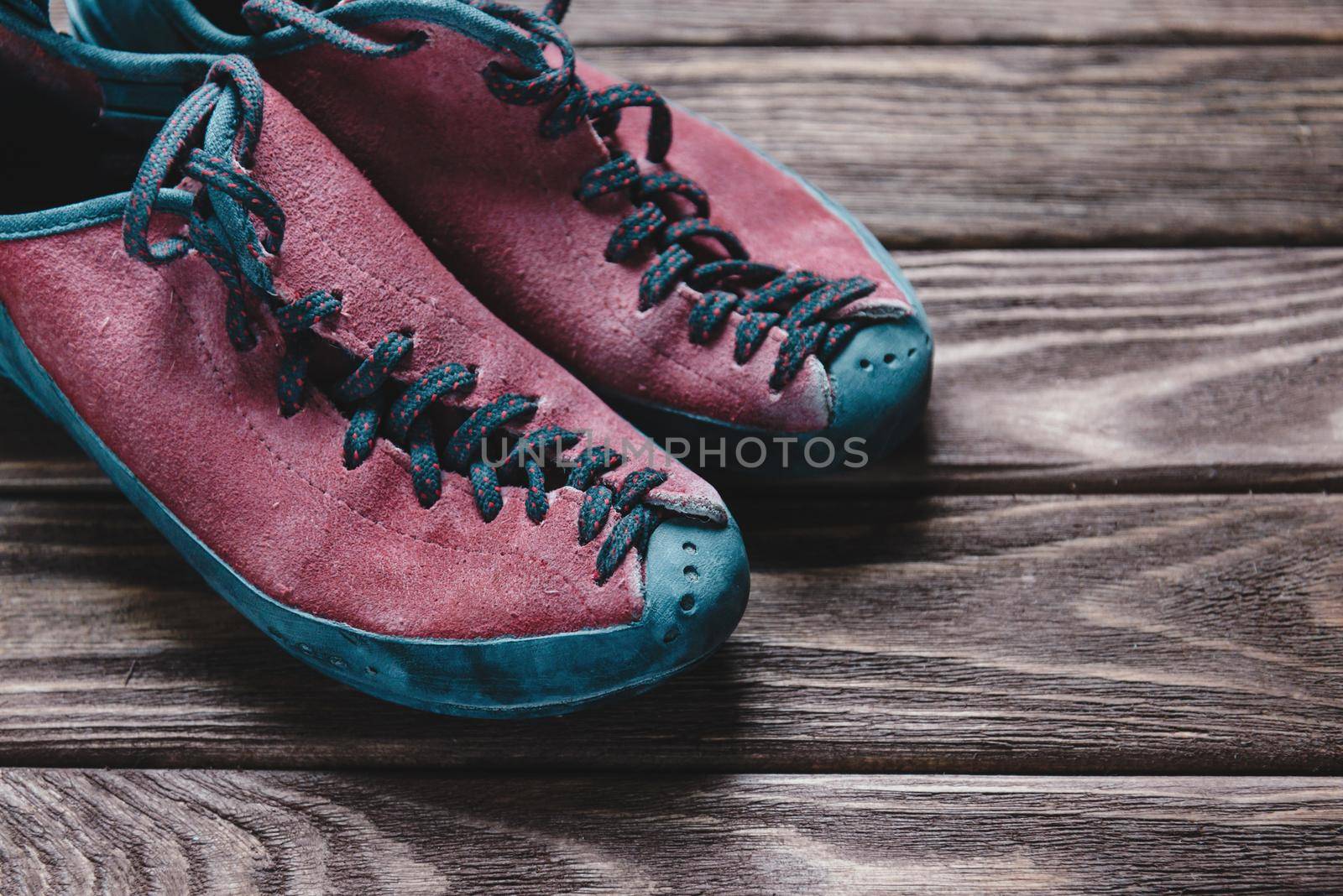 Shoes for climbing sport on a wooden background.