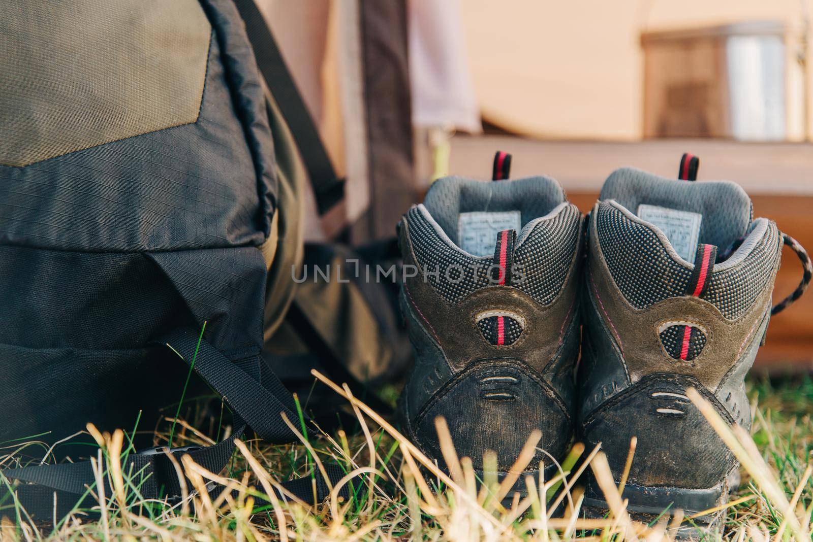 Trekking boots near the backpack outdoor.