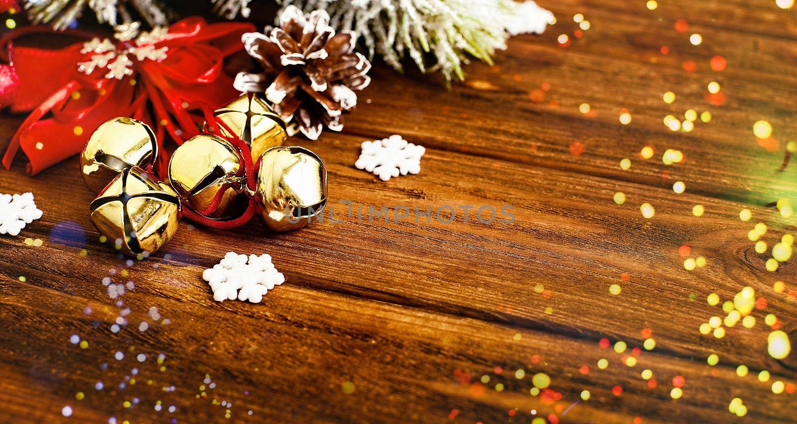 Christmas wooden background with snow fir tree. View with copy space . Copy space framed by Christmas tree branches, decorations, sweets.