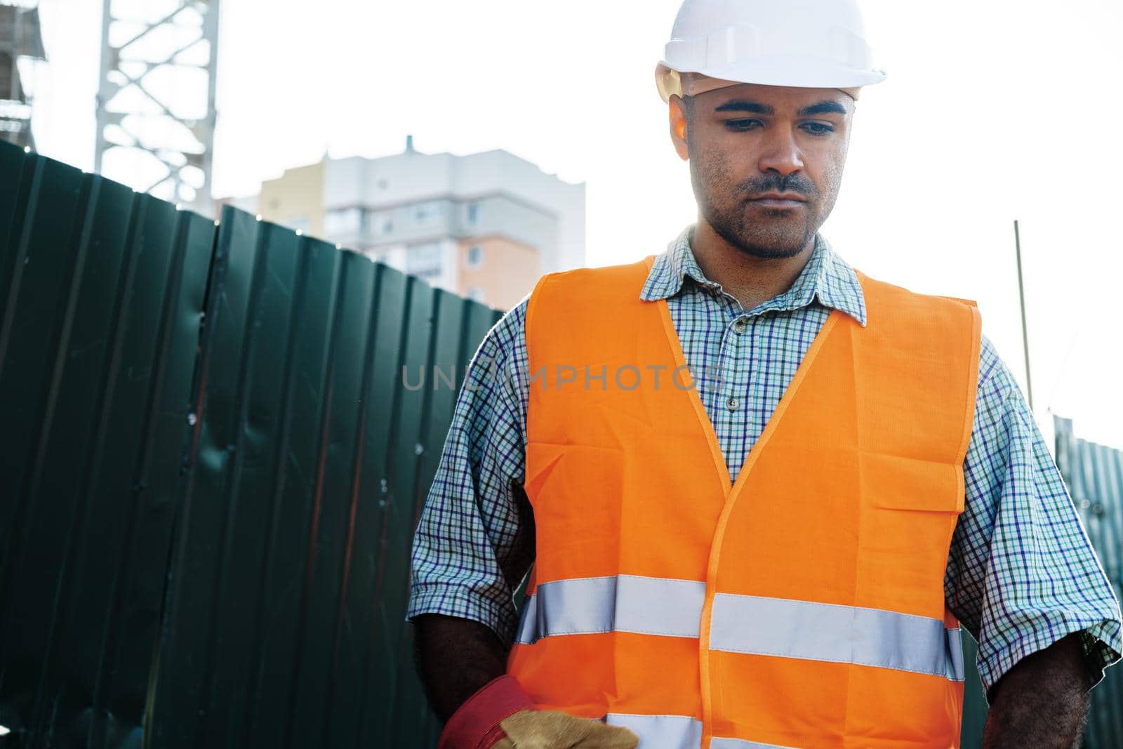 Portrait of young construction engineer wearing hardhat, close up