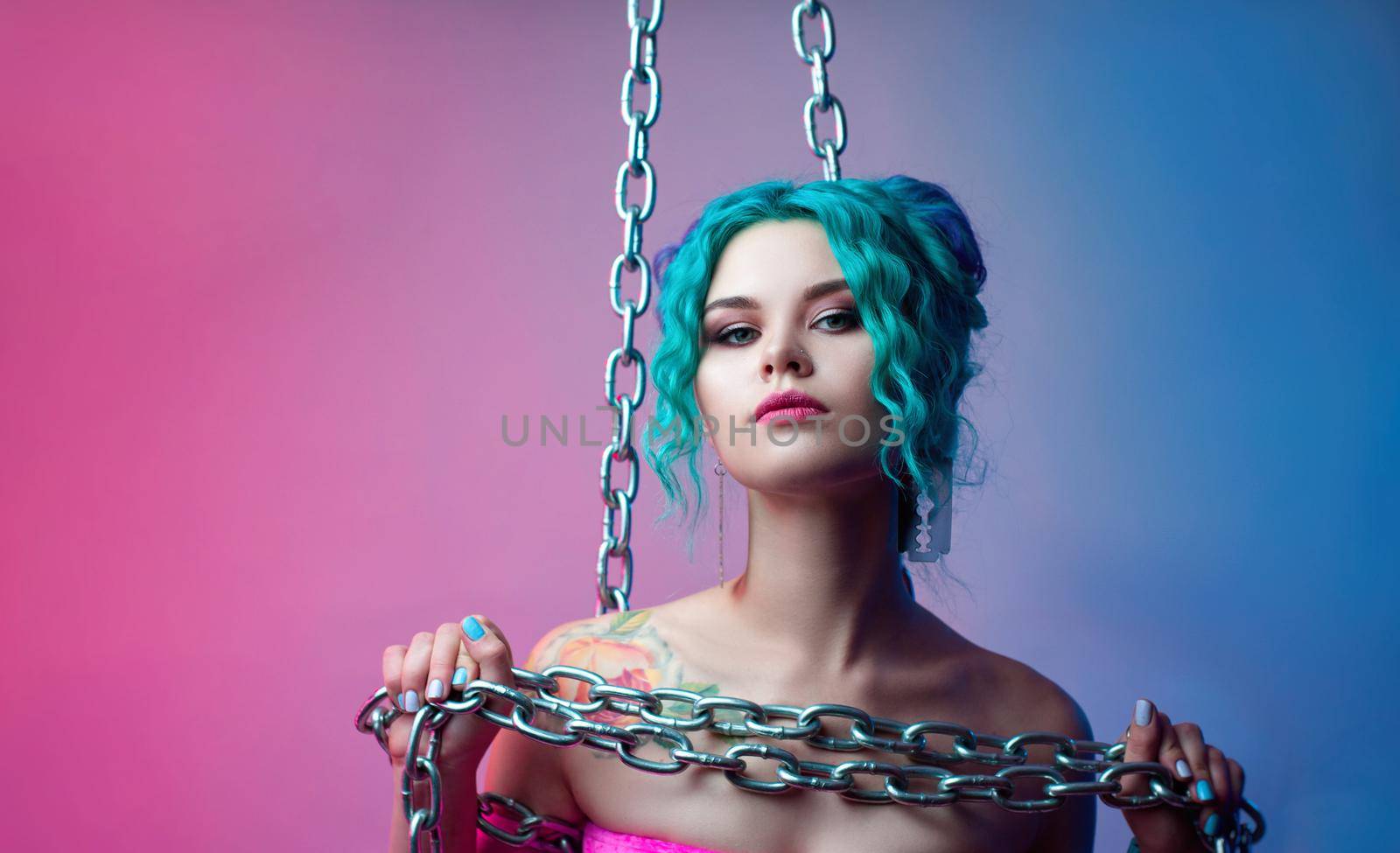 the woman with blue hair is holding a large chain