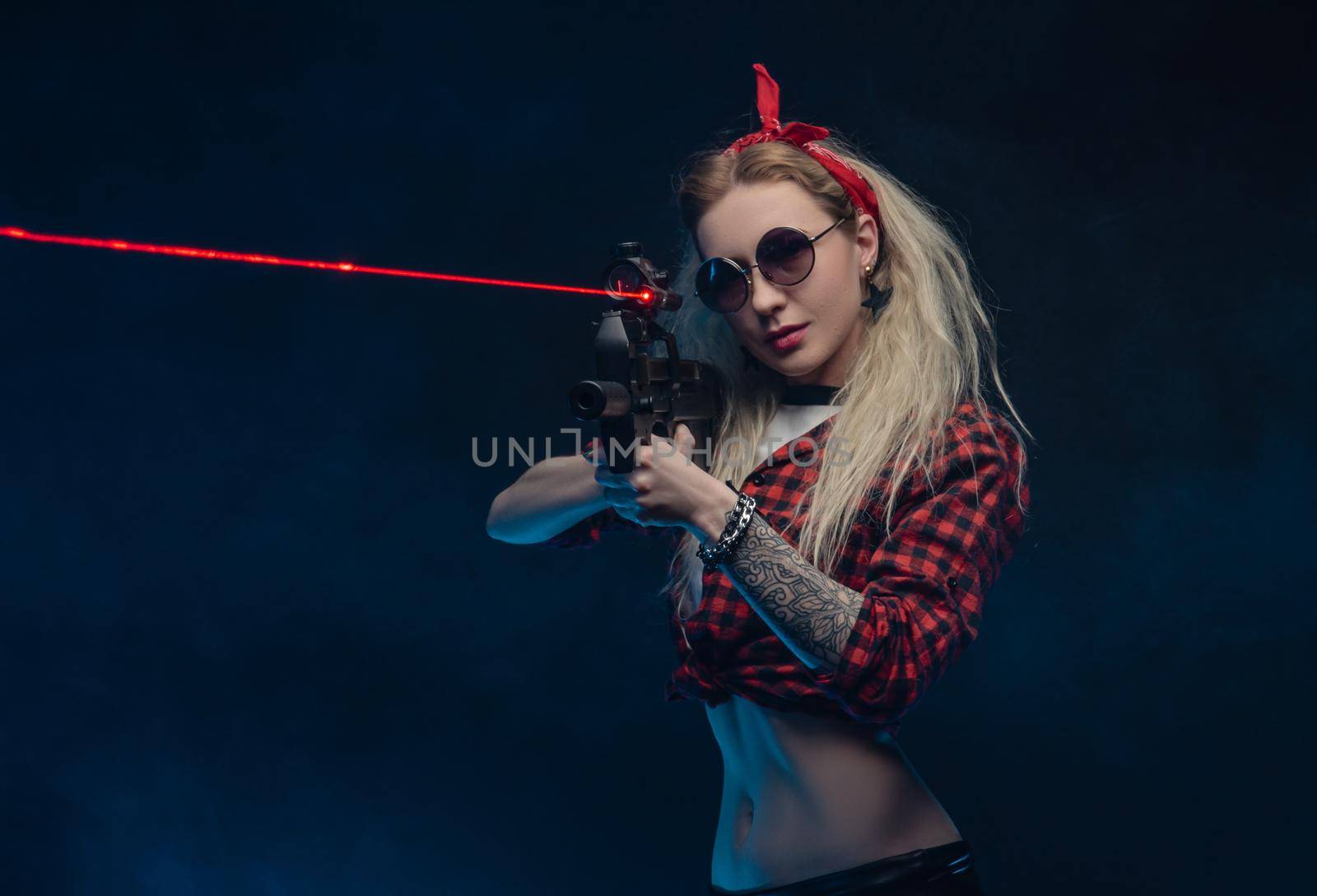 a bright blonde in a red hat with a submachine gun on a dark background by Rotozey