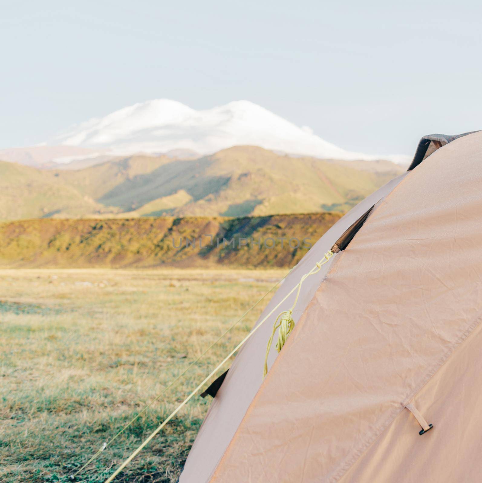 Camping tent on background of Elbrus mountain in summer.