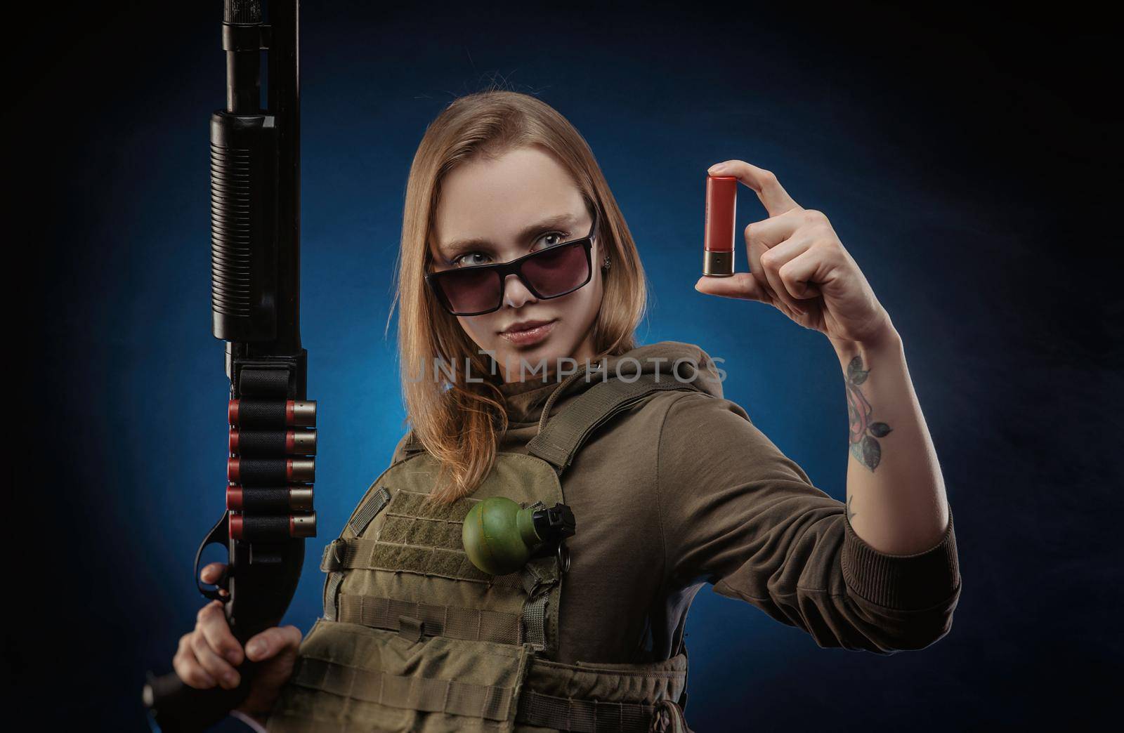 the girl in military overalls airsoft posing with a gun in his hands on a dark background by Rotozey