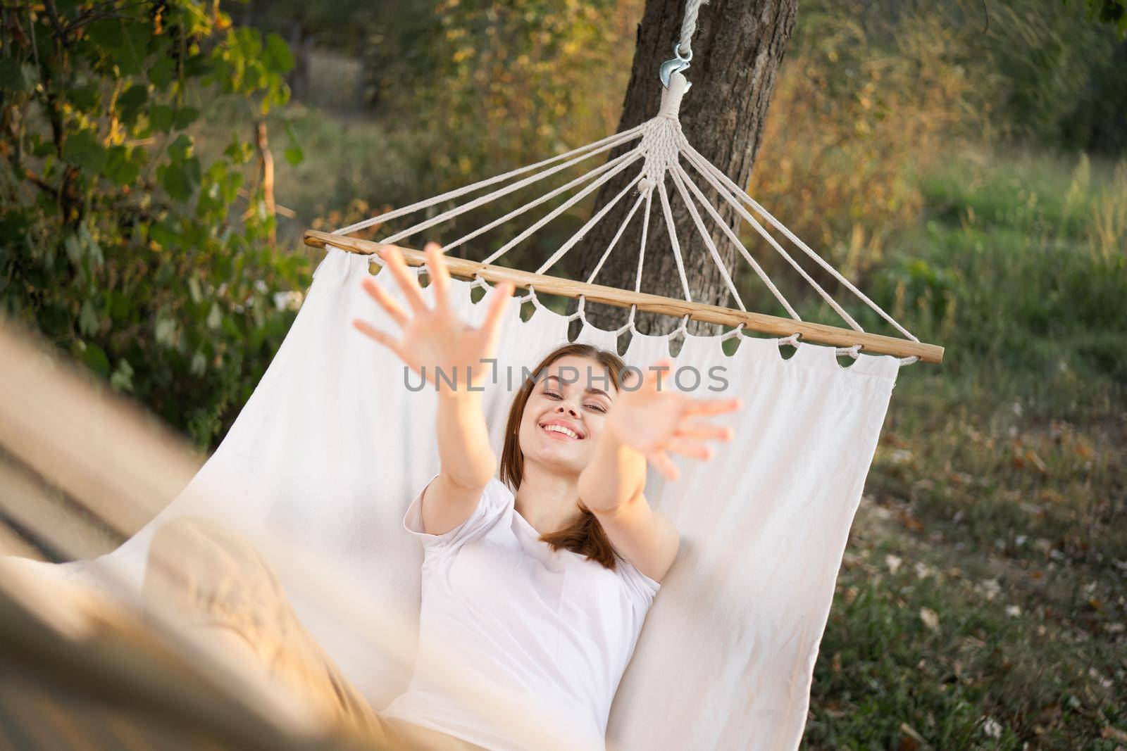 woman relaxing in nature in a hammock garden fresh air. High quality photo