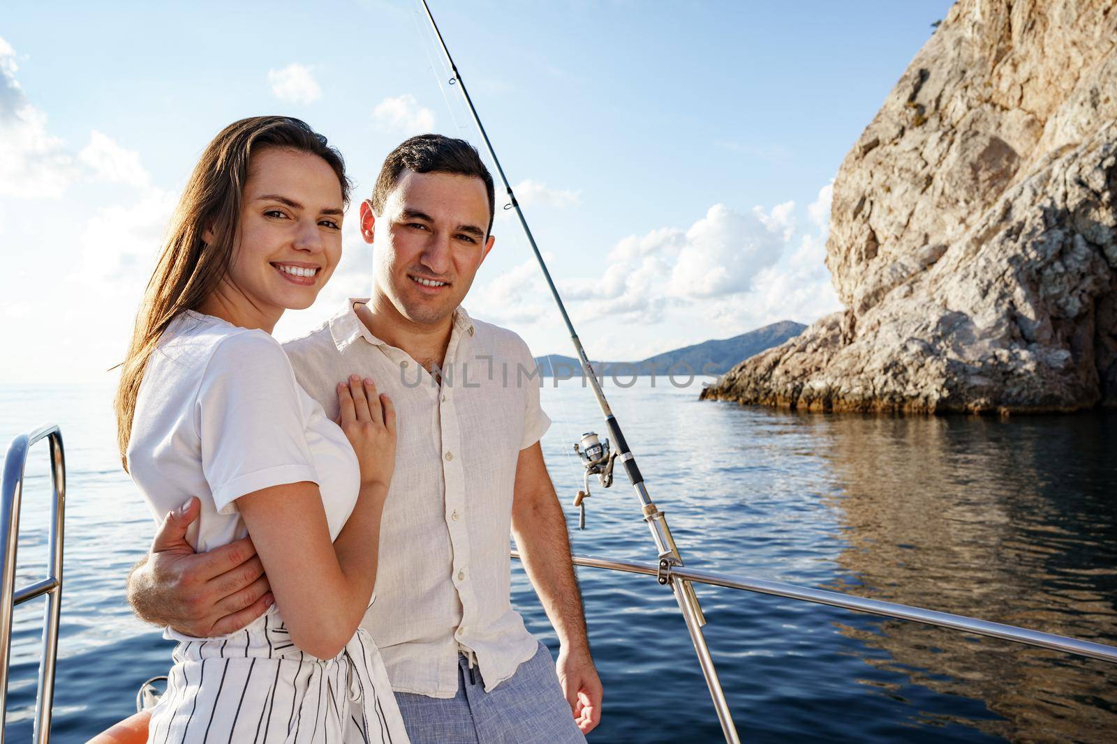 Happy couple in love on a yacht in summer on romantic vacation