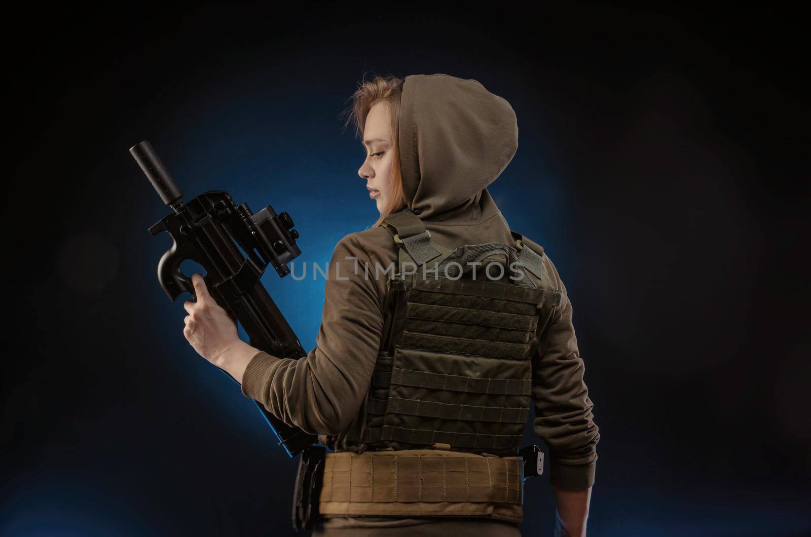 the girl in military overalls airsoft posing with a gun in his hands on a dark background by Rotozey