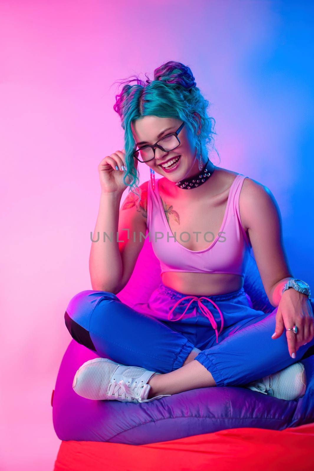 a woman in bright clothes with blue hair is sitting on a chair bag by Rotozey