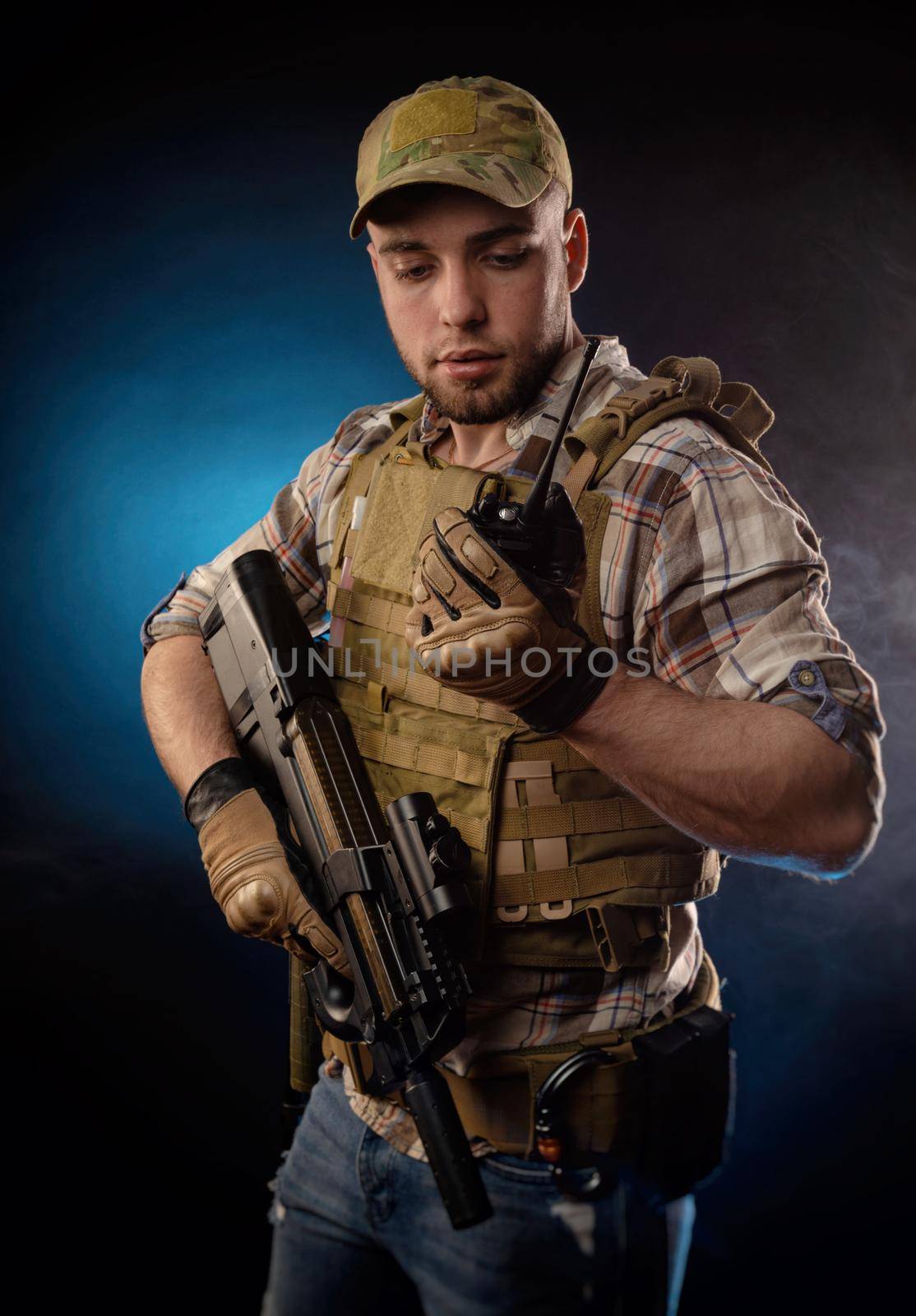 the guy's a military agent in a bulletproof vest with an automatic rifle