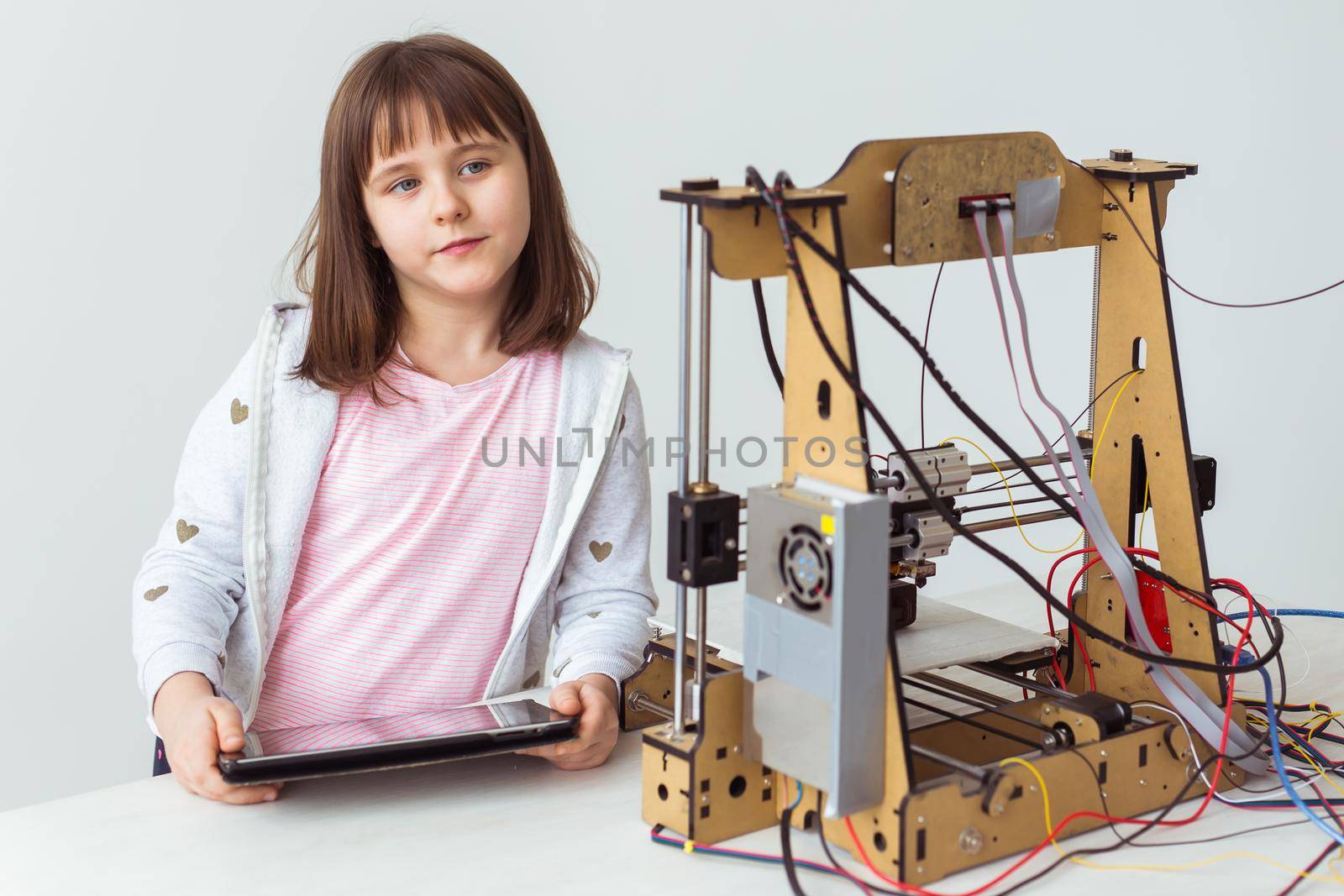 Little child architect using 3D Printer. Schoolgirl, technologies and study concept. by Satura86