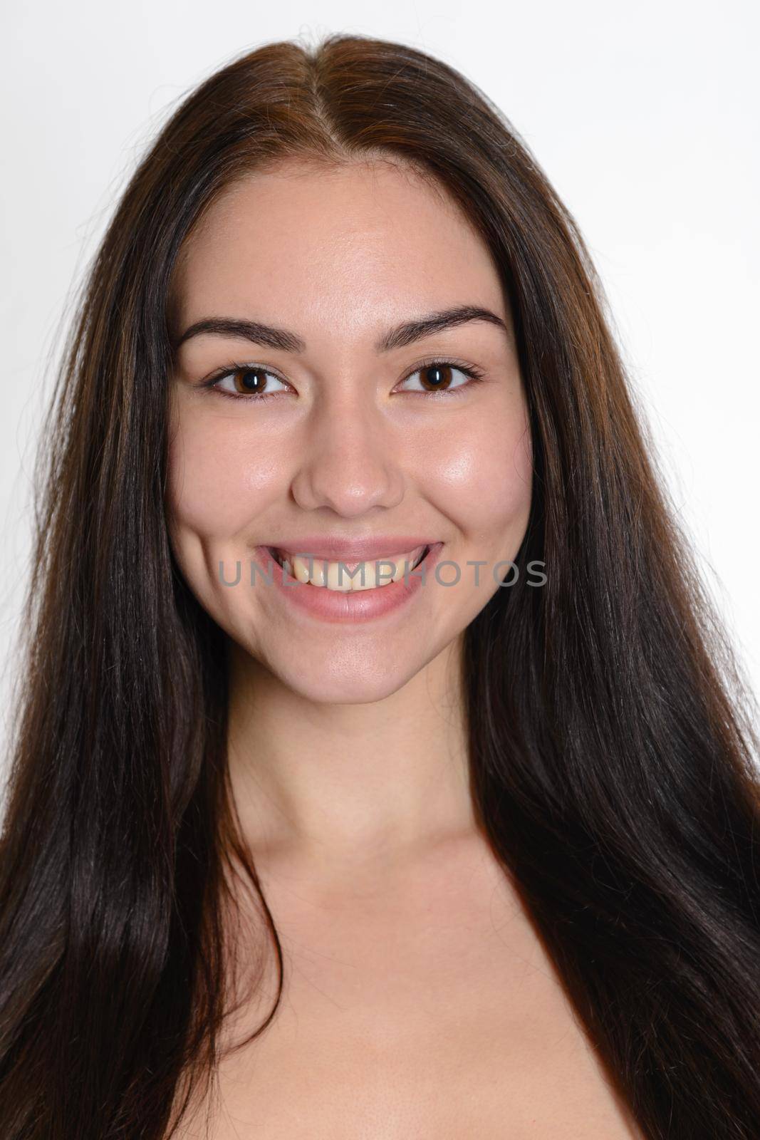 Close-up portraits of beautiful smiling young brunette girl with long flowing hair Spa Woman Smiling. Perfect Fresh Skin. Pure Beauty Model. Youth and Skin Care Concept