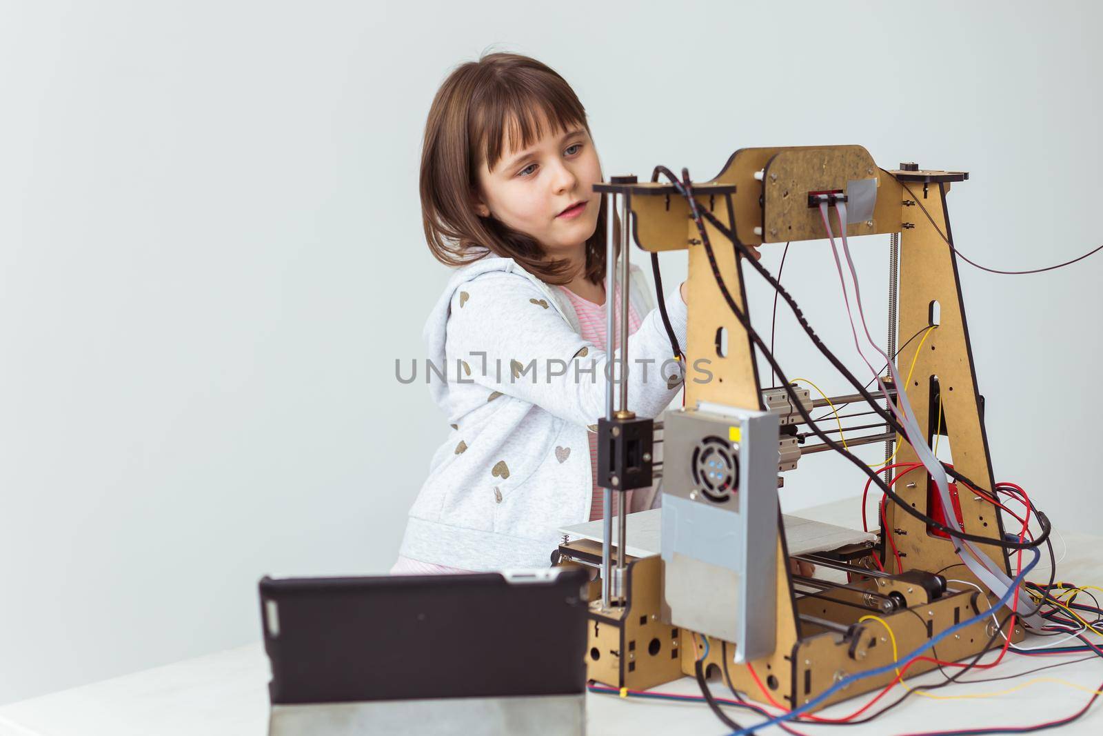 Child student makes the item on the 3D printer. School, technologies and science.