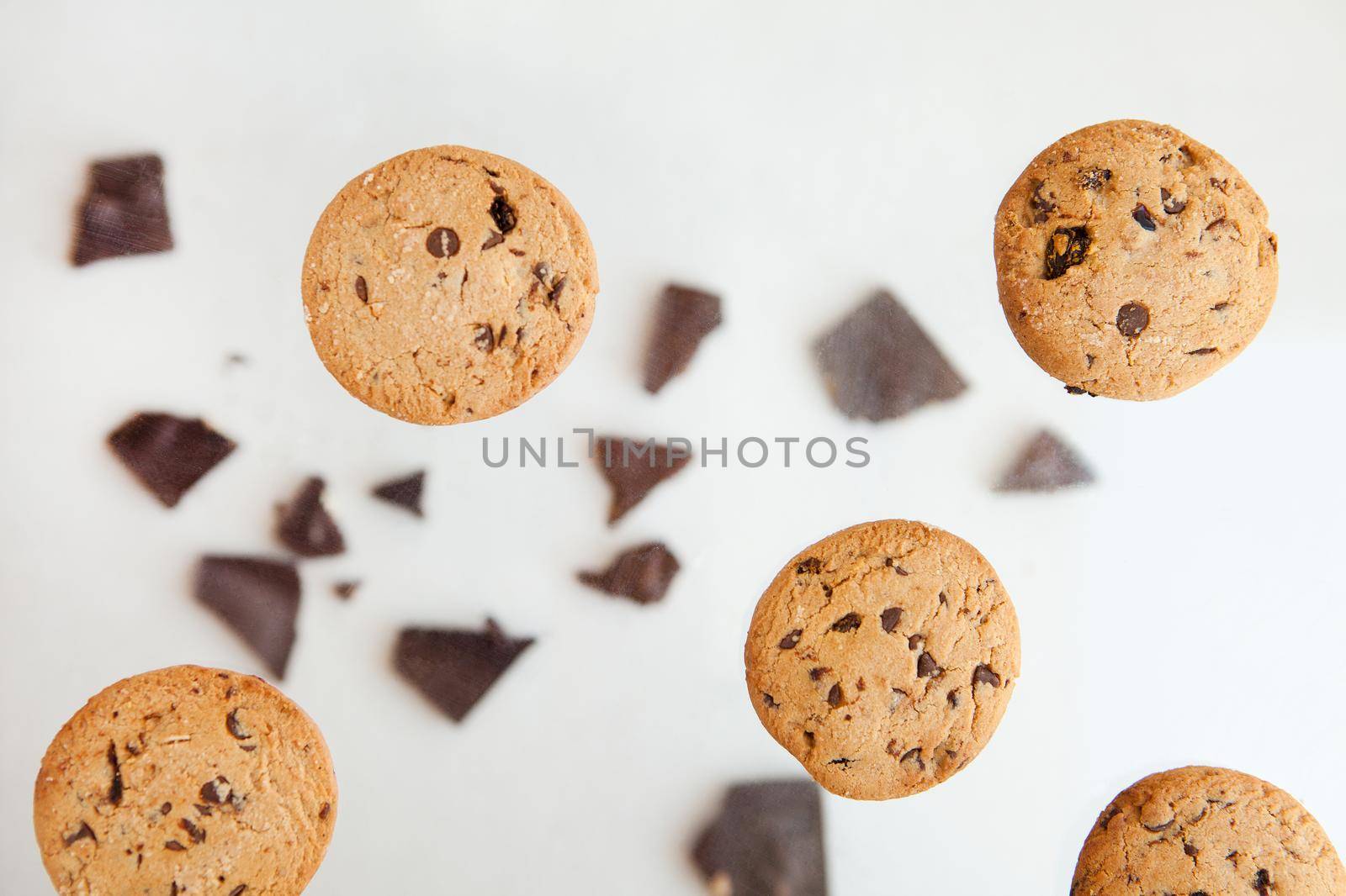 Homemade bakery and dessert. chocolate cookies flying - Chocolate chip cookie with crumbs on gray background.