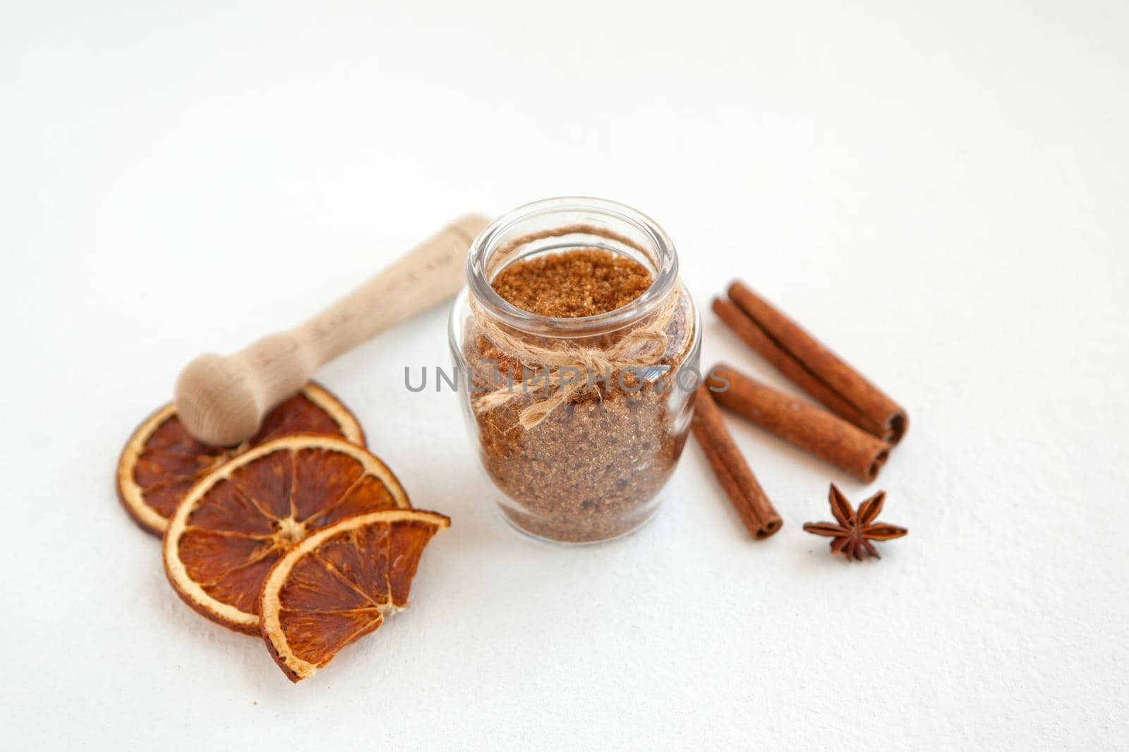 Cinnamon sticks and star anise on brown sugar with shallow depth of field on white background. Baking ingredients for cooking