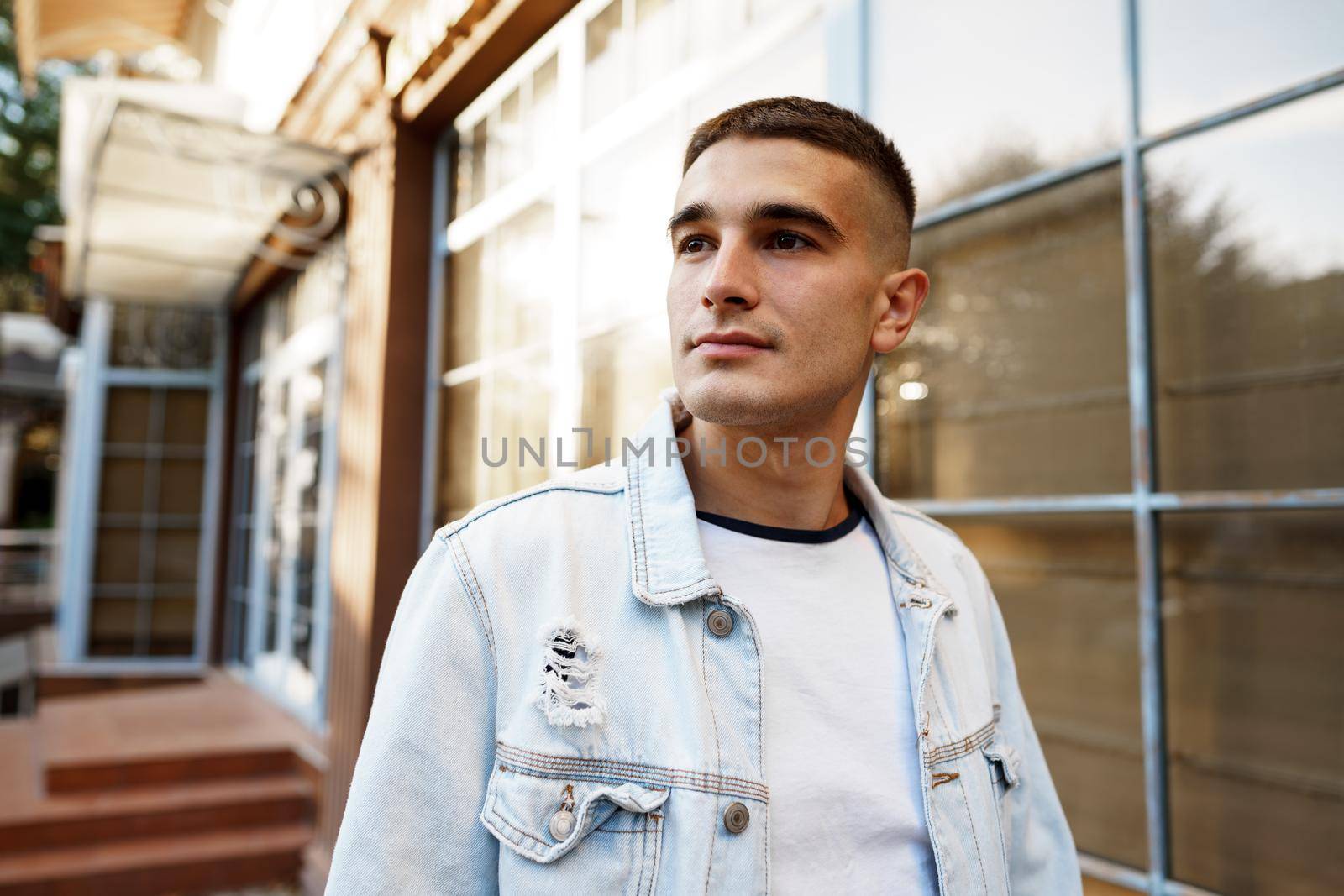 Portrait of handsome young casual man walking on the city street