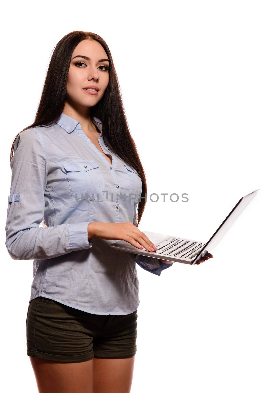 A smiling Oriental girl in a denim shirt was opened laptop on a white background