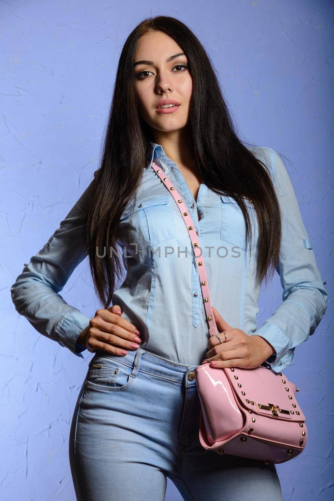 Charming brunette with long hair holding a pink handbag by zartarn