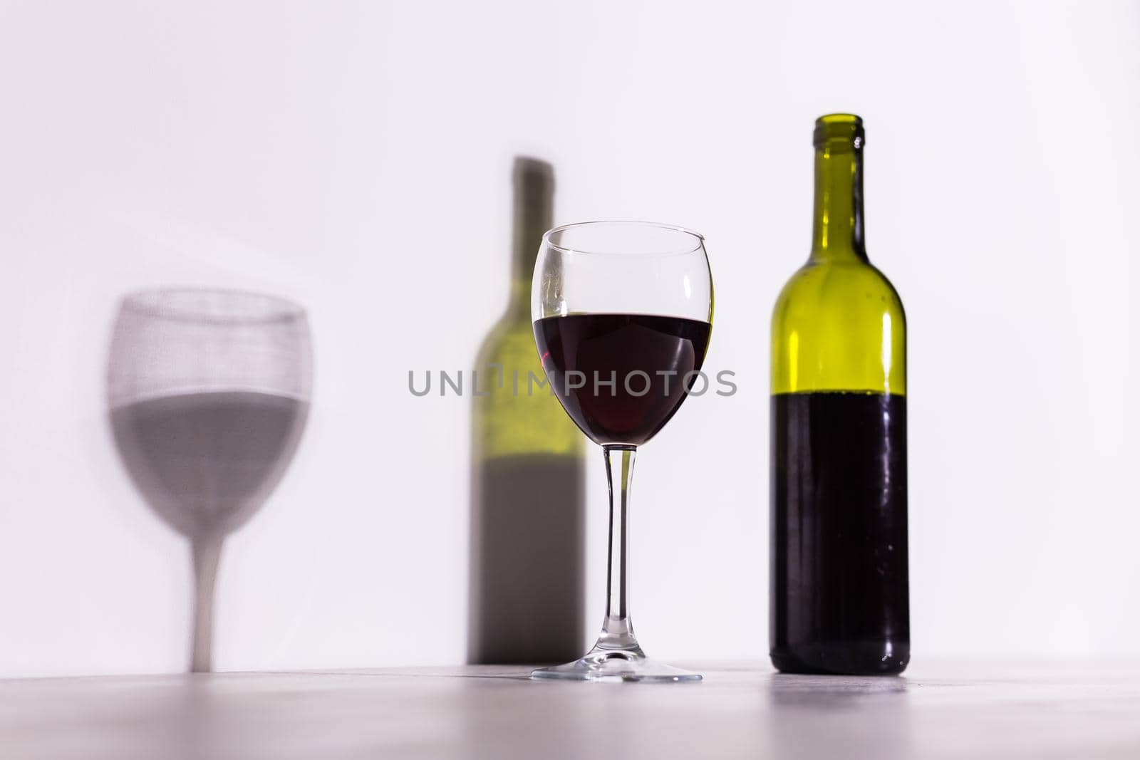 Shadow of wine glass in dark light. by Satura86