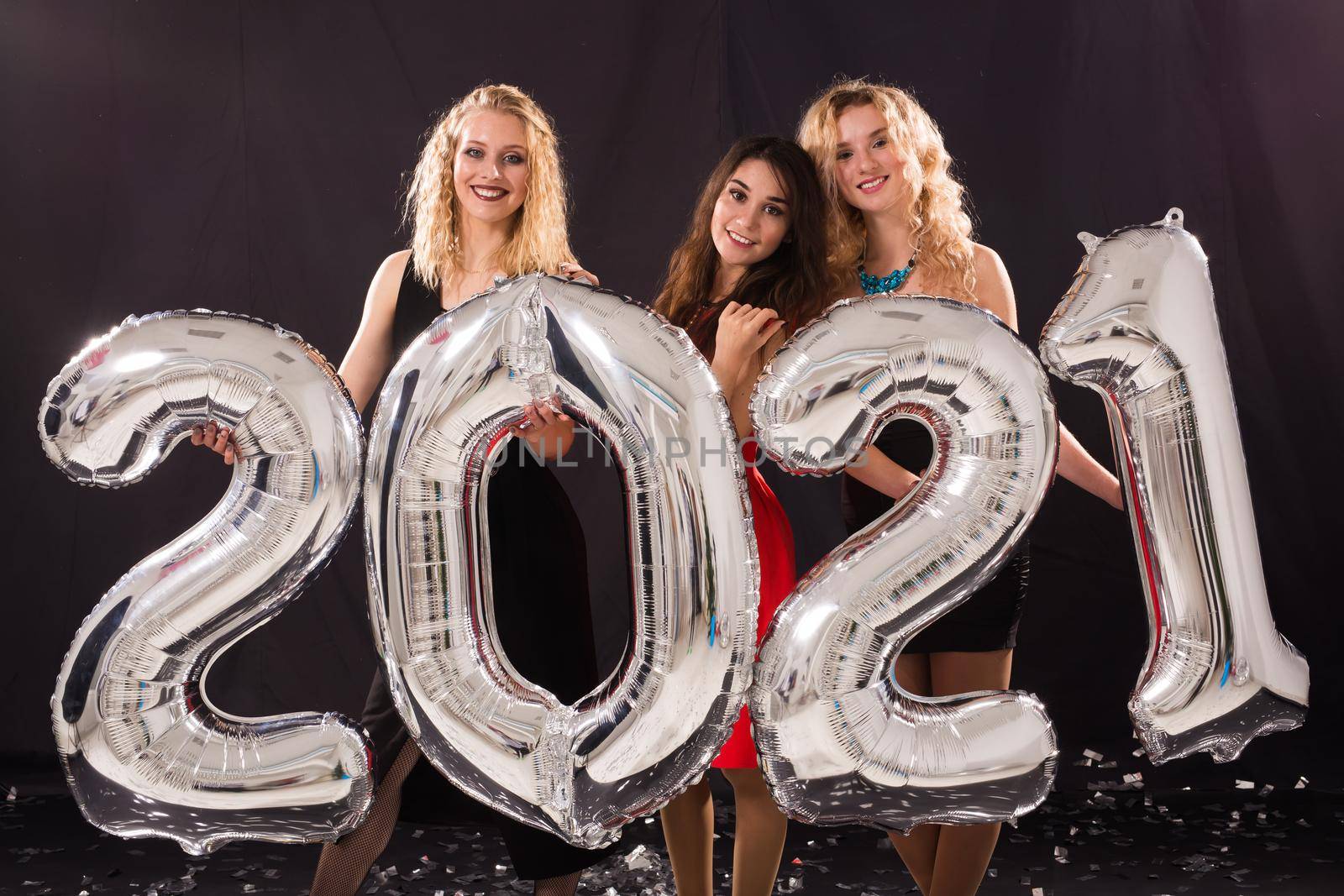 Party, people and new year holidays concept - cheerful young women celebrating new years eve 2021 by Satura86