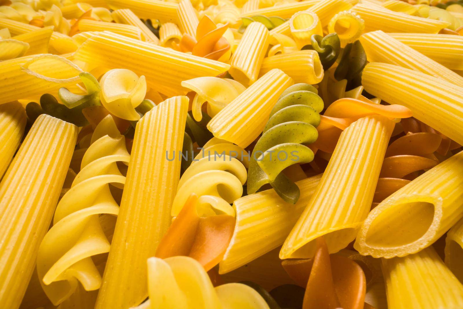 Variety of types and shapes of dry Italian pasta closeup. Food and traditional cuisine.