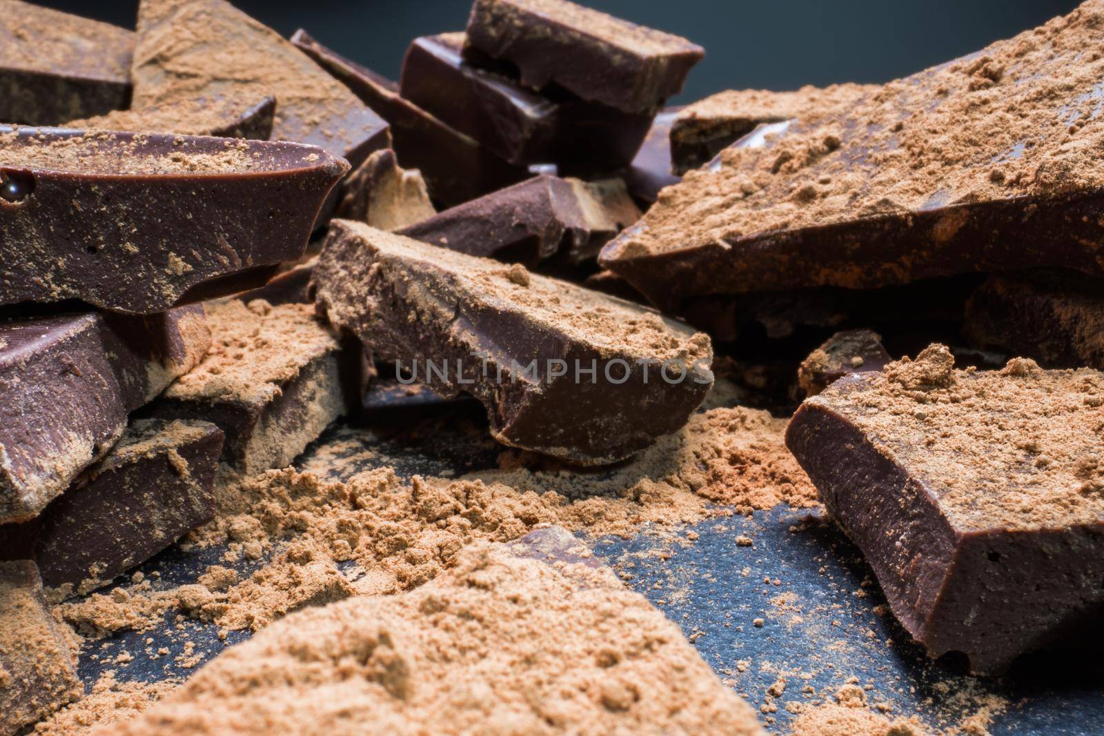 Chopped chocolate with cocoa, big pieces. Dessert, sugar, carbohydrates and fats.