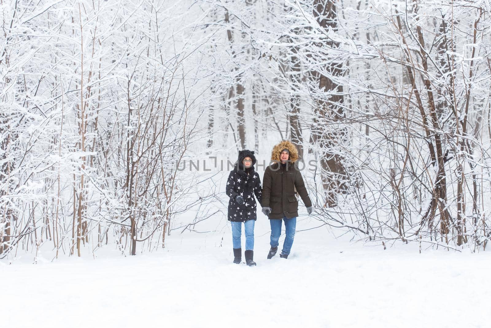 Happy loving couple having fun outdoors in snow park. Winter vacation by Satura86