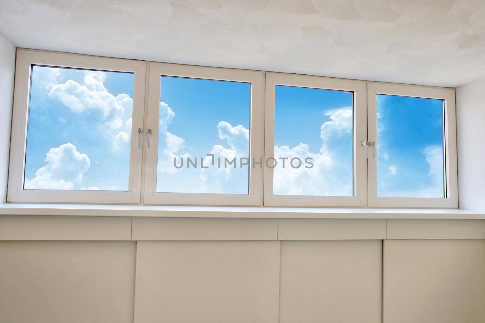 Fresh white modern dormer window with blue sky and white clouds view, New dormer, roof window in empty new house closeup