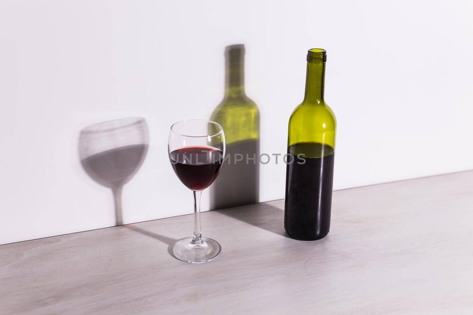 Shadow of wine glass in dark yellow light