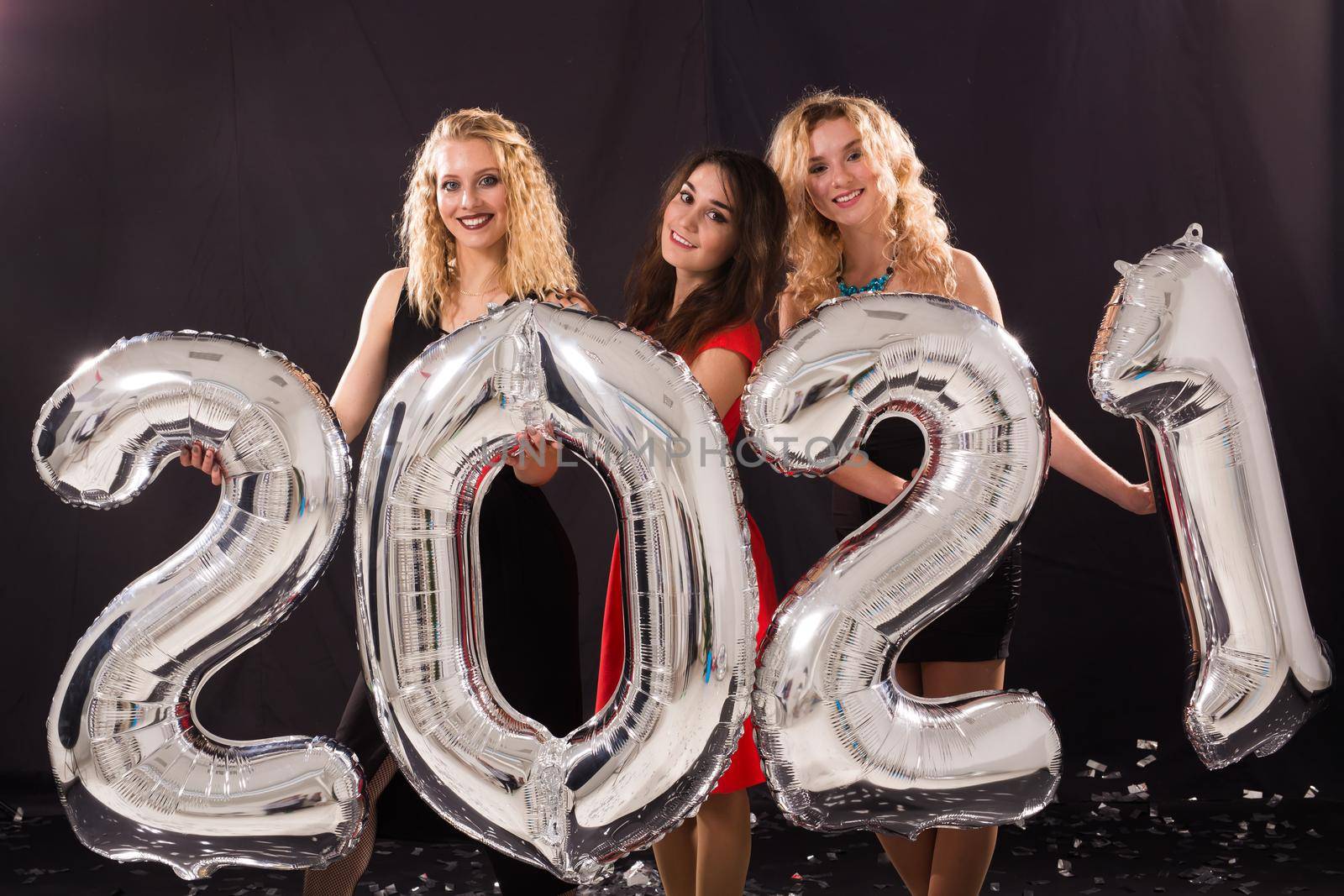 Party, people and new year holidays concept - cheerful young women celebrating new years eve 2021 by Satura86
