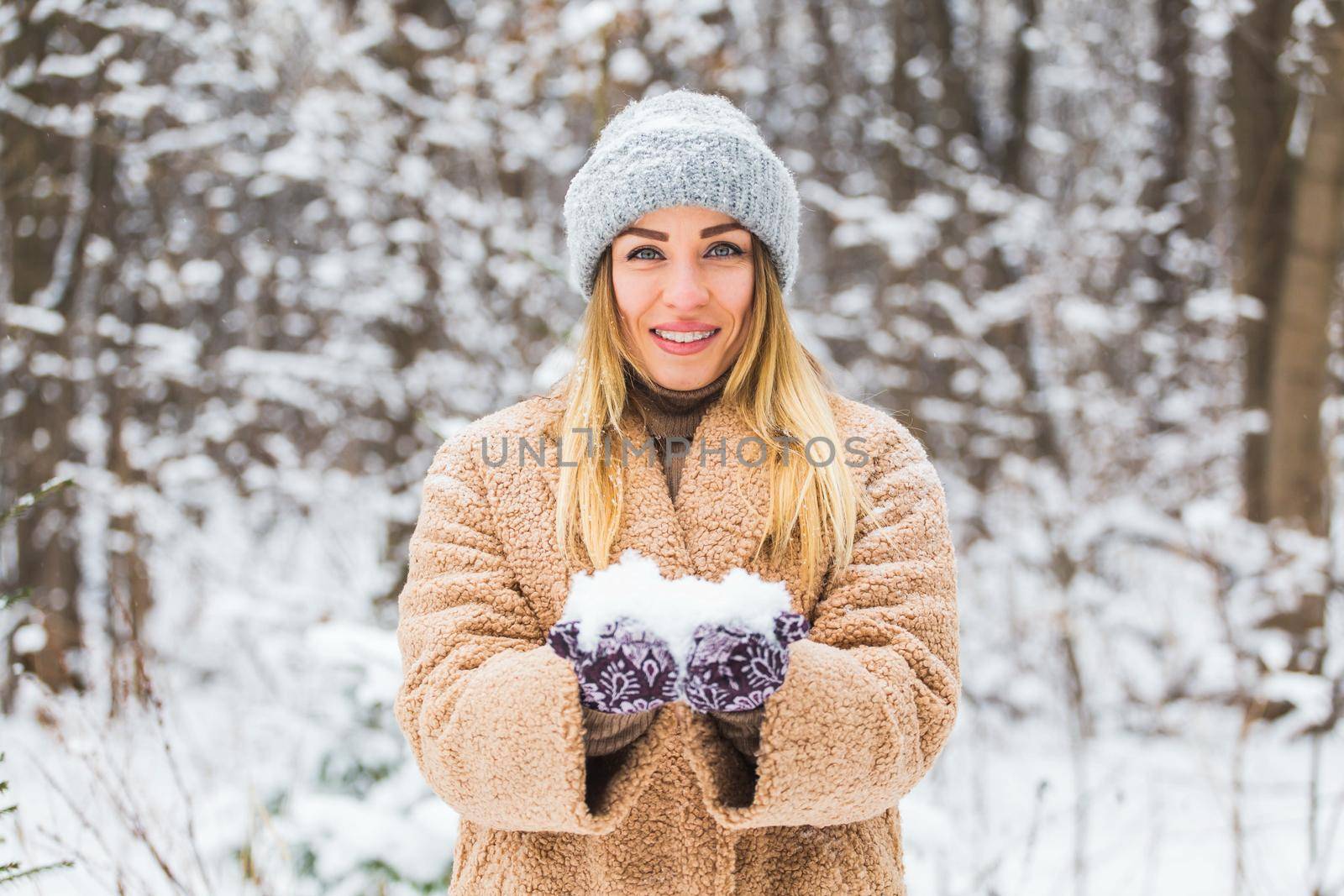 Close up of woman holding the snowball in hands, winter concept with copy space