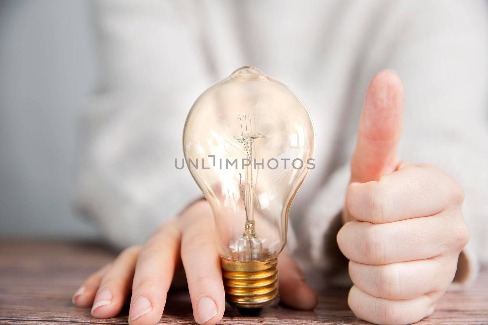 Shining lightbulb with thumbs up, Good Idea and brainstorming, creative business or education concept background modern style by Annebel146