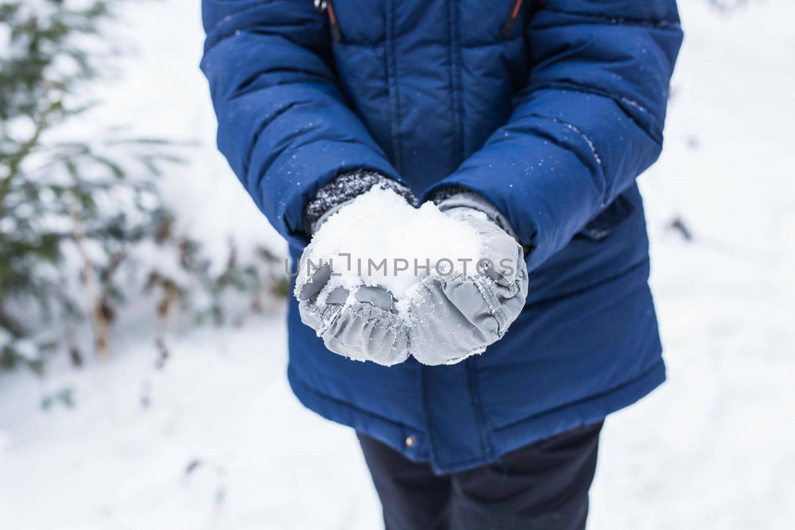 Happy boy throwing snow. Child, season and winter concept