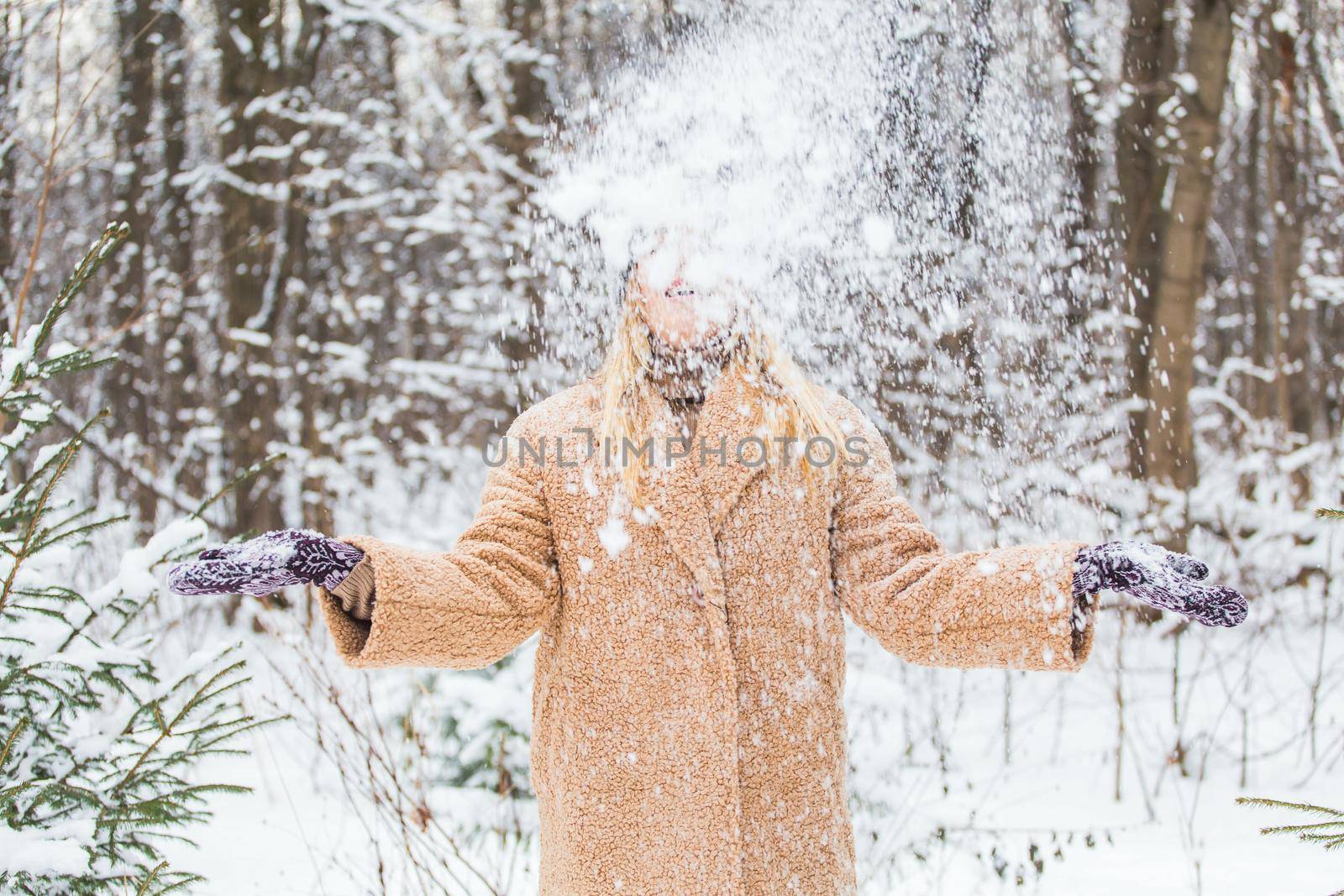 Woman throws up snow, fun and winter.