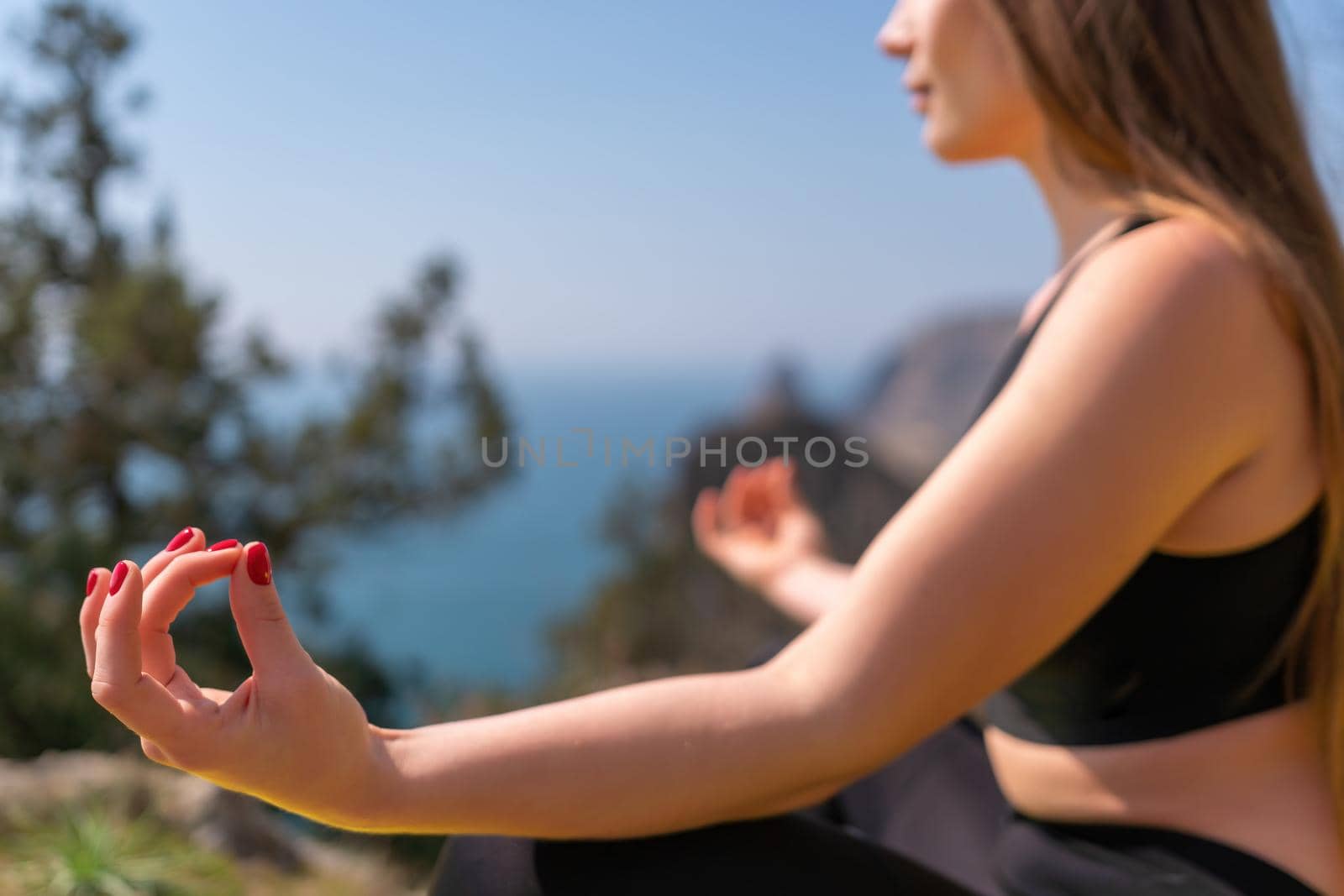 Group of young womans fitness instructor in Sportswear Leggings and Tops, stretching in the gym before pilates, on a yoga mat near the large window on a sunny day, female fitness yoga routine concept.