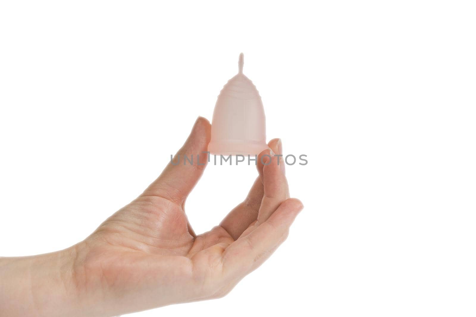 Womans hand holding menstrual cup, period cup isolated on white background with copy space, alternative product zero waste eco friendly closeup