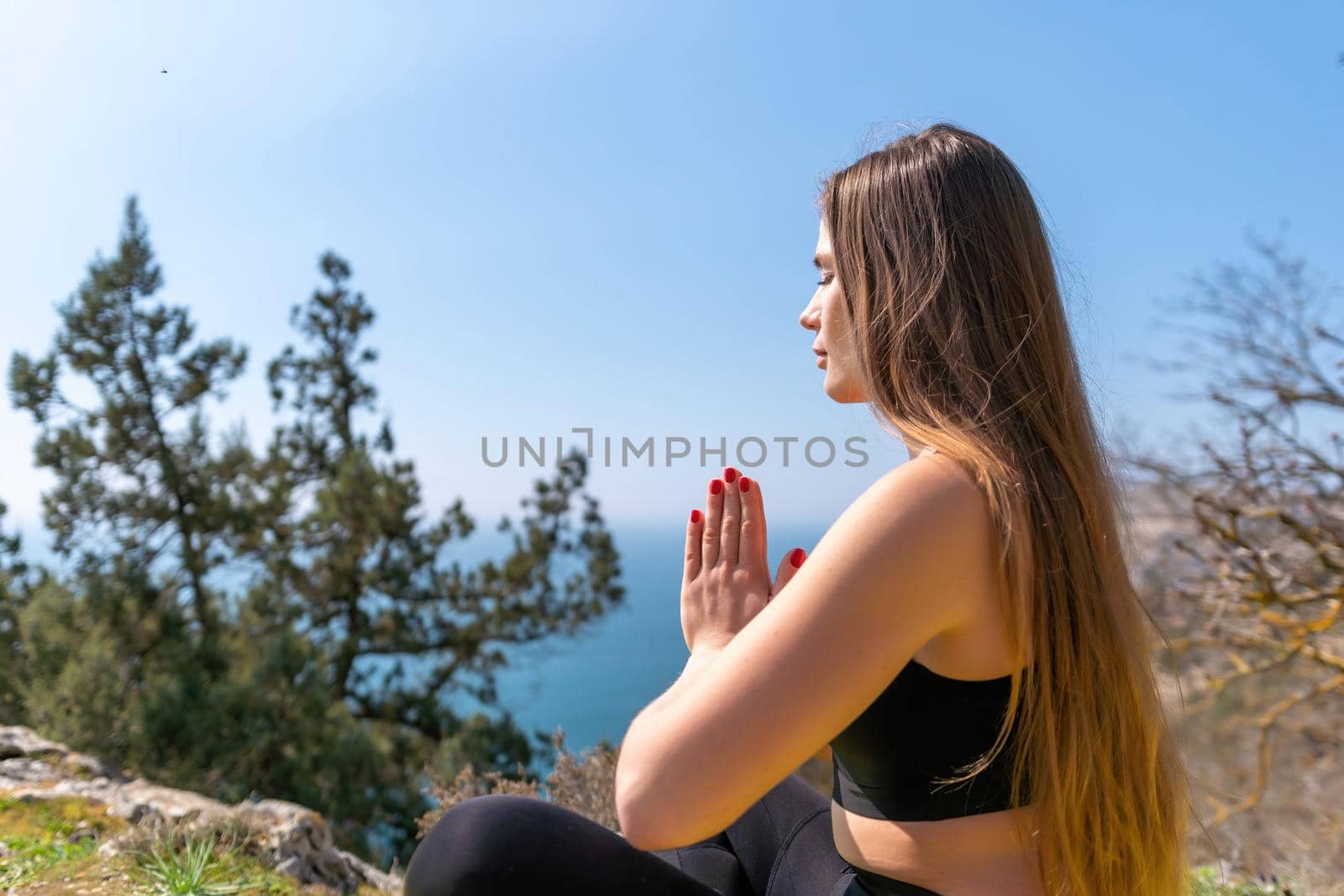 Group of young womans fitness instructor in Sportswear Leggings and Tops, stretching in the gym before pilates, on a yoga mat near the large window on a sunny day, female fitness yoga routine concept.